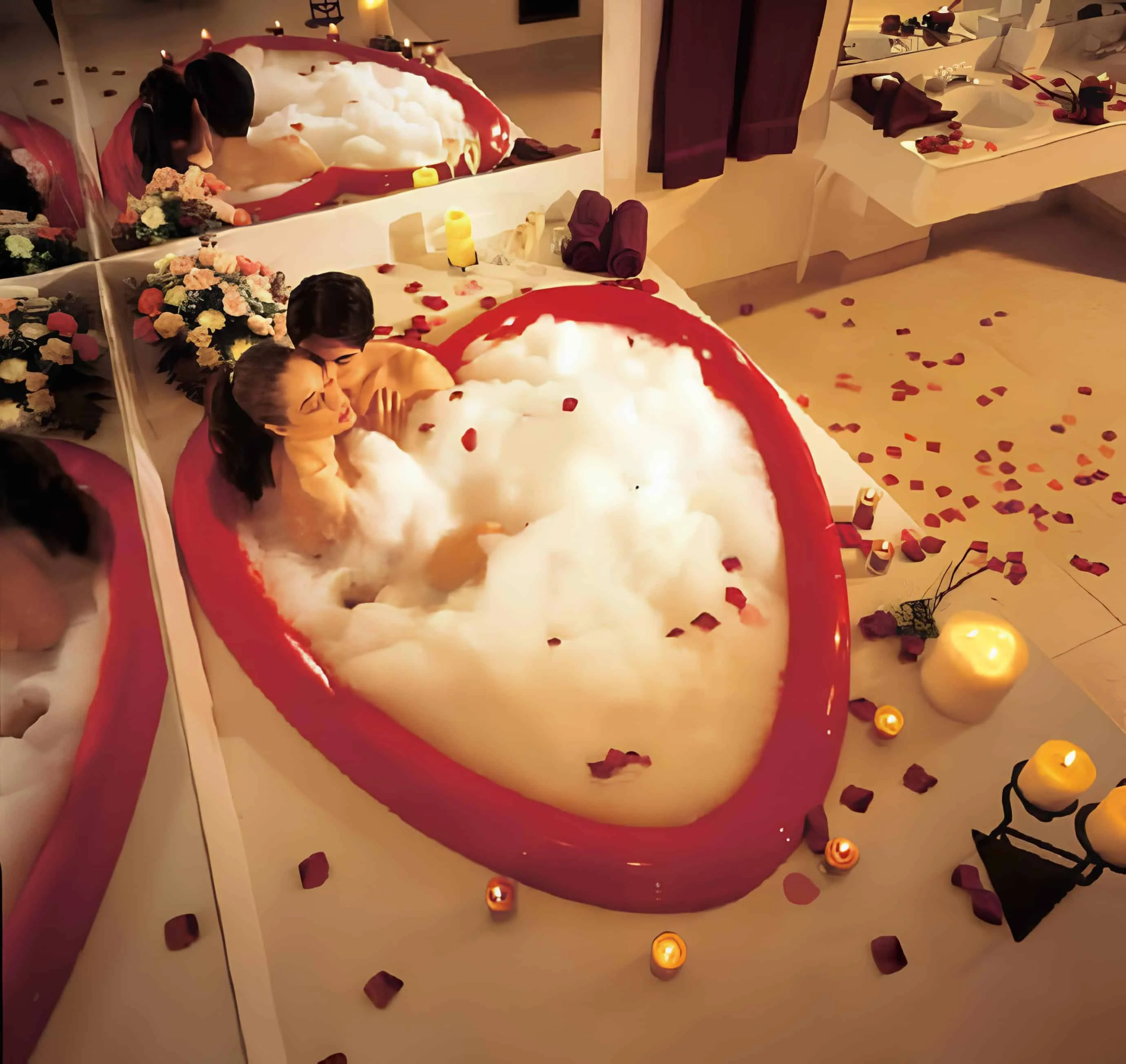 Red heart-shaped bathtub surrounded by candles and rose petals
