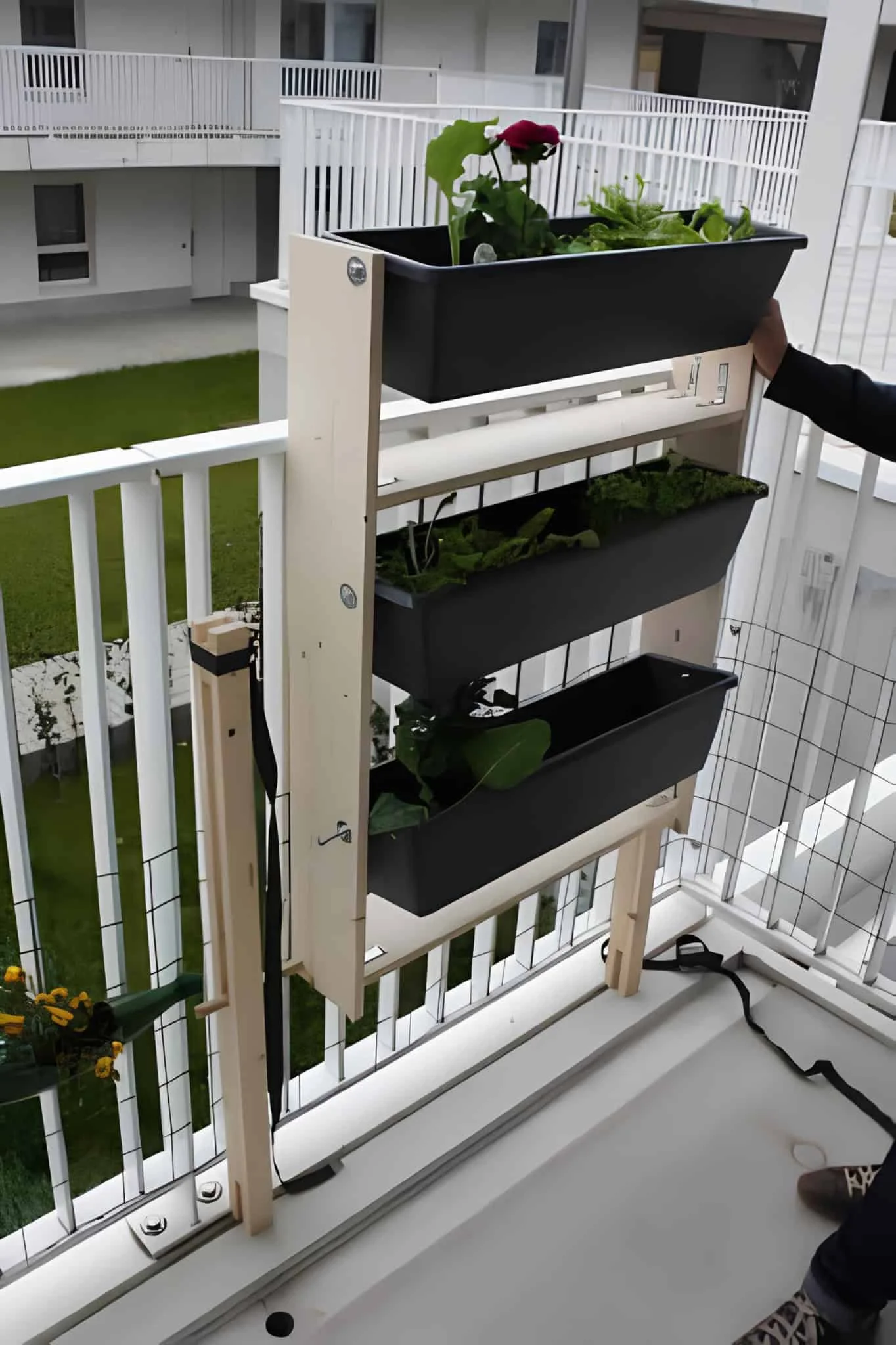 Slim vertical planter for balconies with black rectangular pots