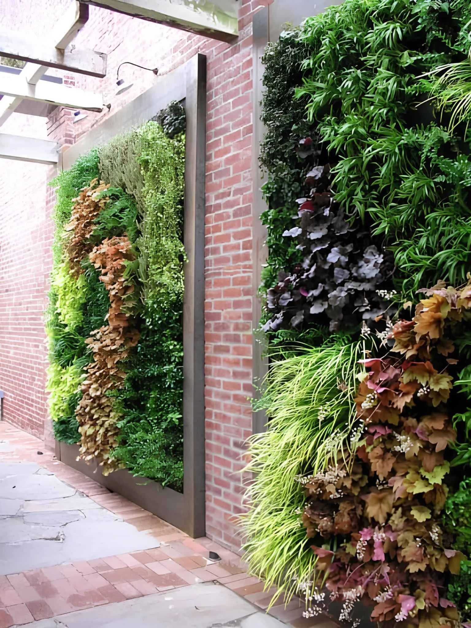 Dramatic plant wall with texture and color on urban brick facade