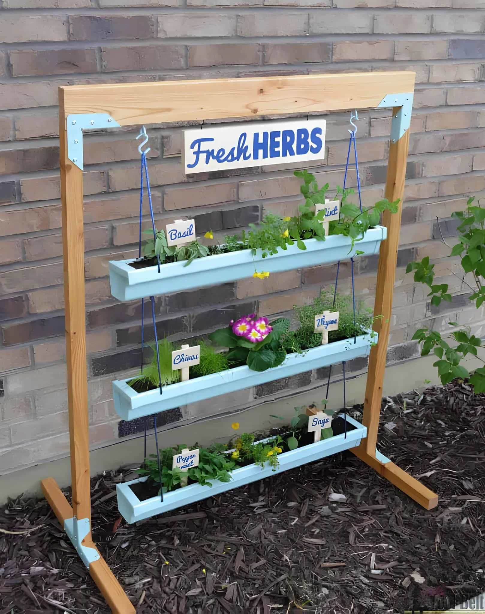 Hanging herb garden using painted gutters and wooden frame