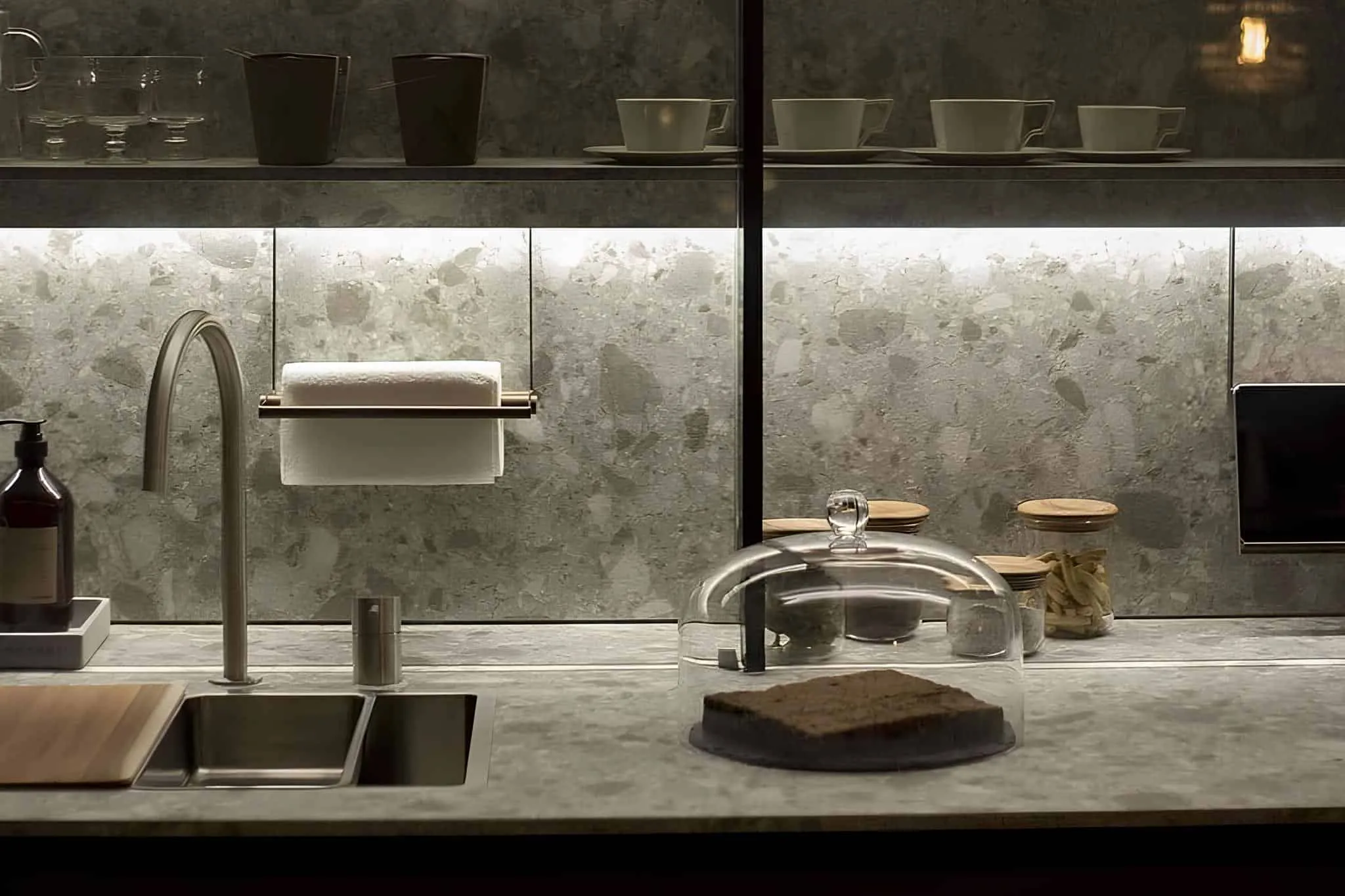 Dark-toned kitchen with gray marble base and under-cabinet lighting