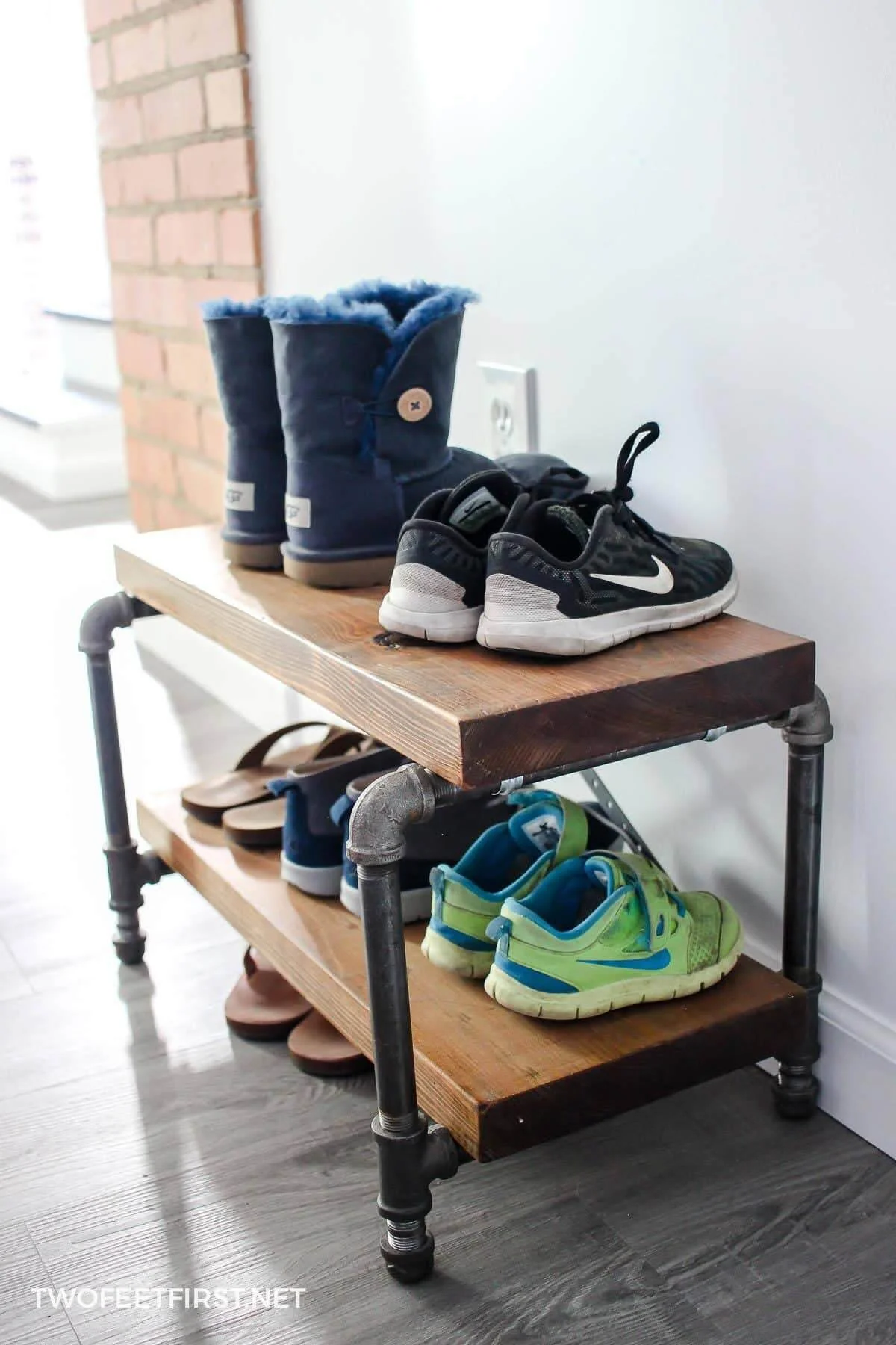 3. DIY Industrial Shoe Stand with Pipes and Wood