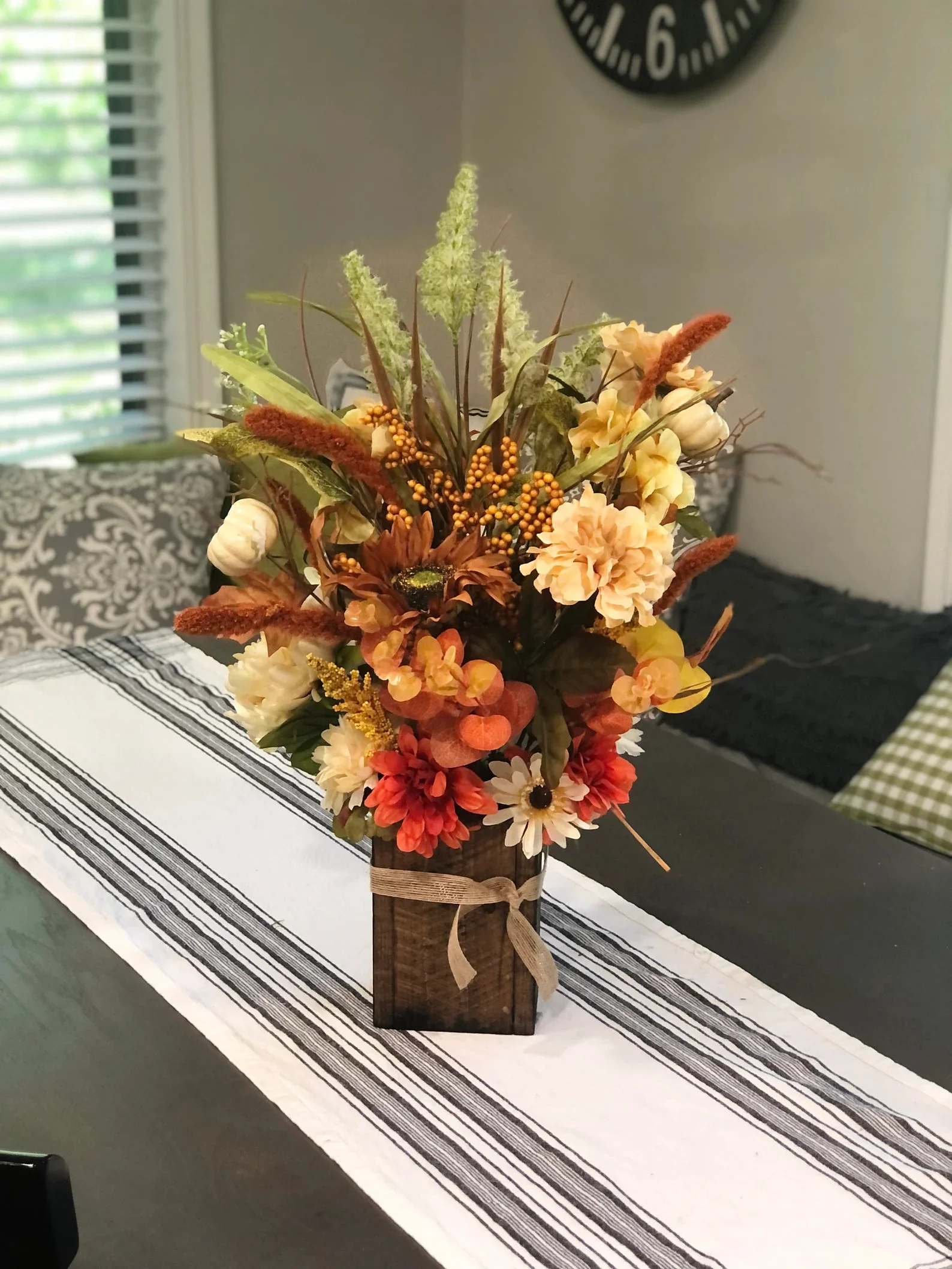 8. Centro de mesa floral con jarrón de madera