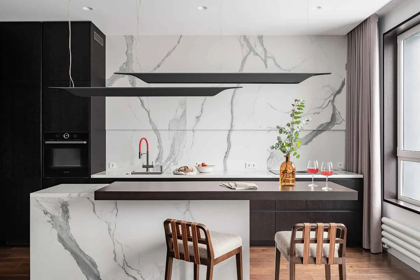 Kitchen and dining area with marble island and warm wood tones