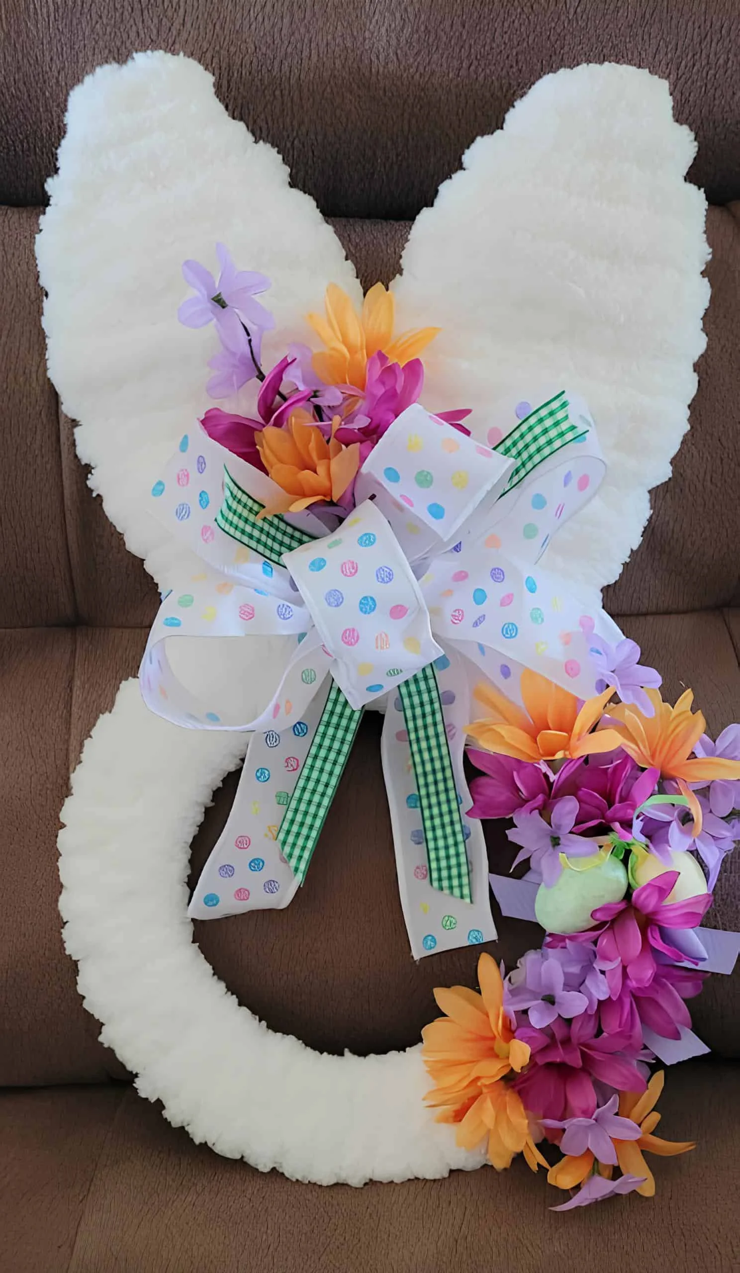DIY guirnalda de Easter con orejas blancas suaves y base, acentuada con flores primaverales, gingham verde y cintas con huevos de Easter - decoración compatible con Dollar Tree para puerta festiva