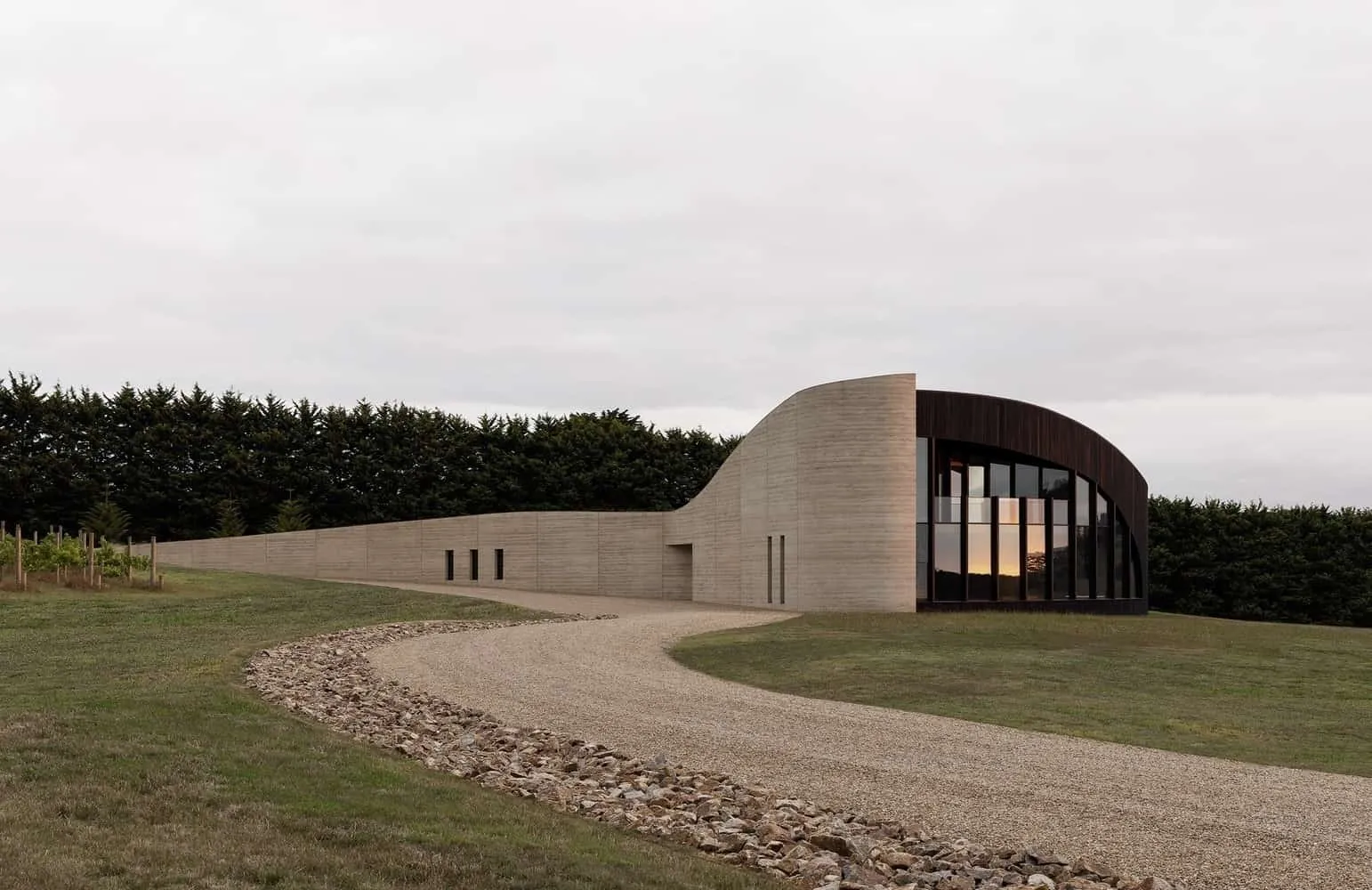 Sinuous wall of compressed earth forming a bold sculptural profile against the horizon