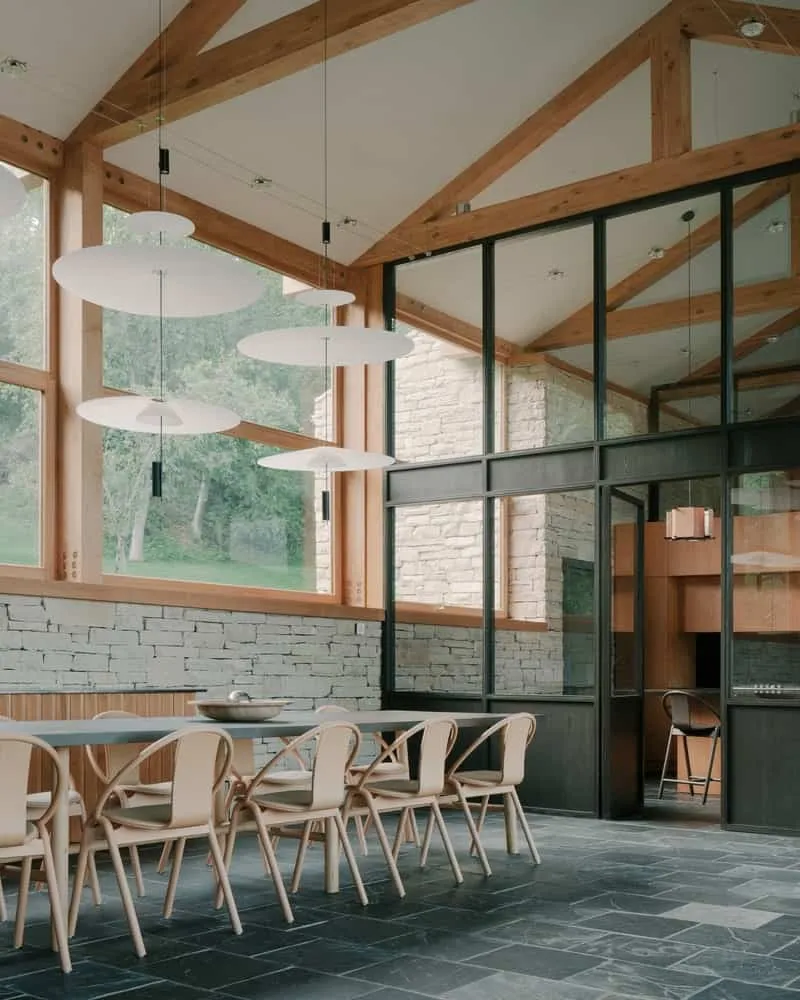 Minimalist interior composition balanced between rough stone and smooth wood and plaster.