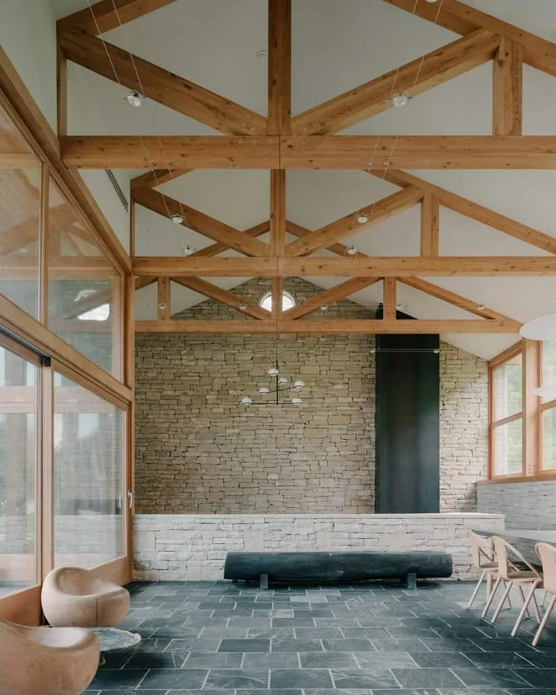 Cozy outdoor threshold with stone tiles and wooden awning forming a peaceful transition zone.