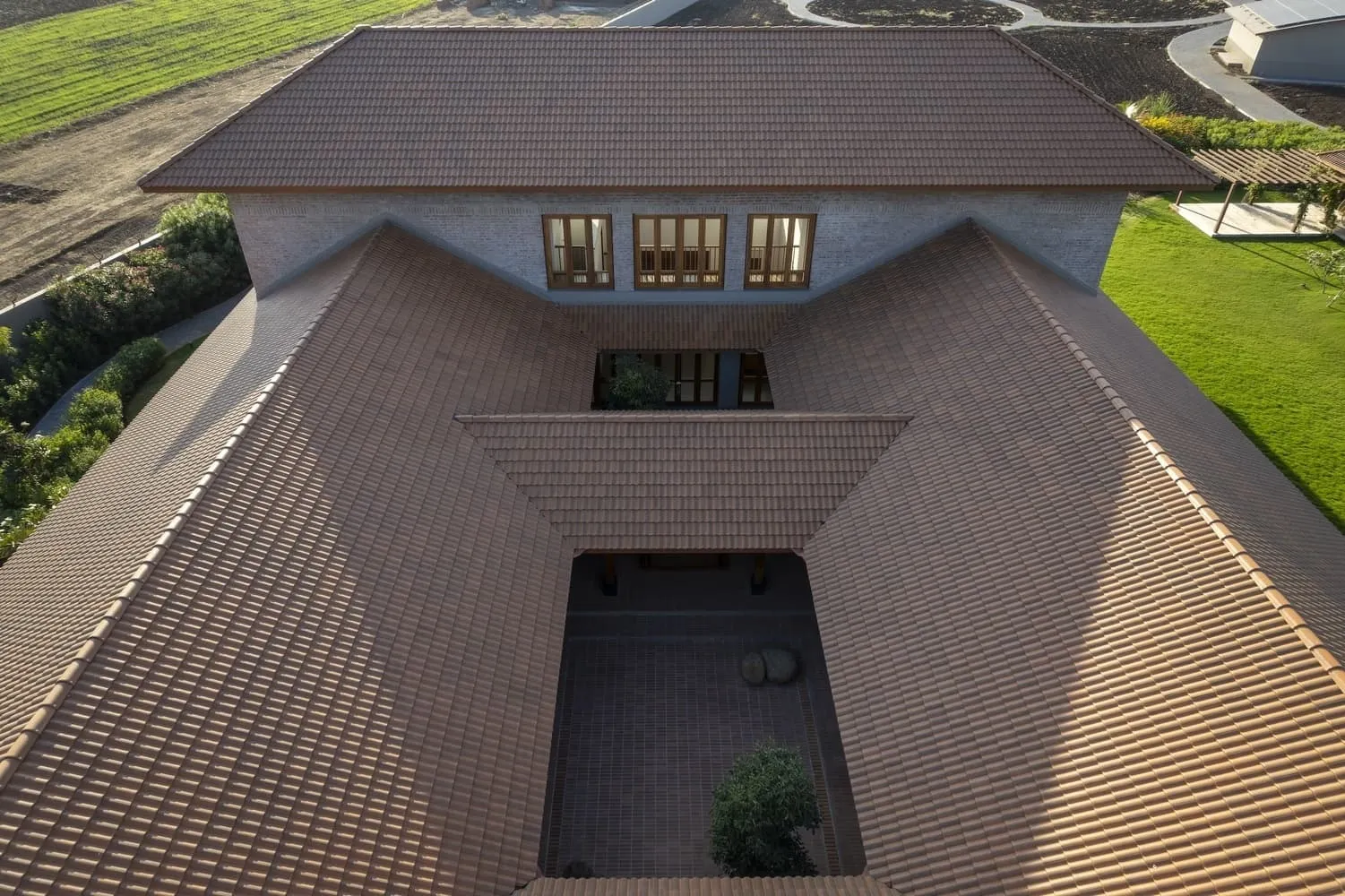 Courtyard illuminated at sunset with warm light embracing stone and brick.