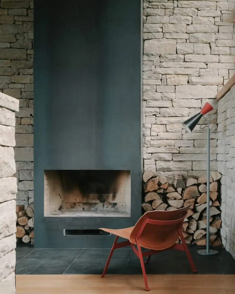 Bedroom with oak floors, soft plastered wall and narrow clerestories for privacy and calm.