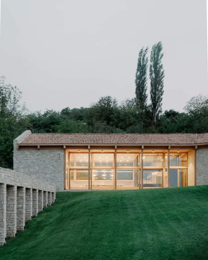 Glazed wing with full-wall windows offering views of Georgian countryside.