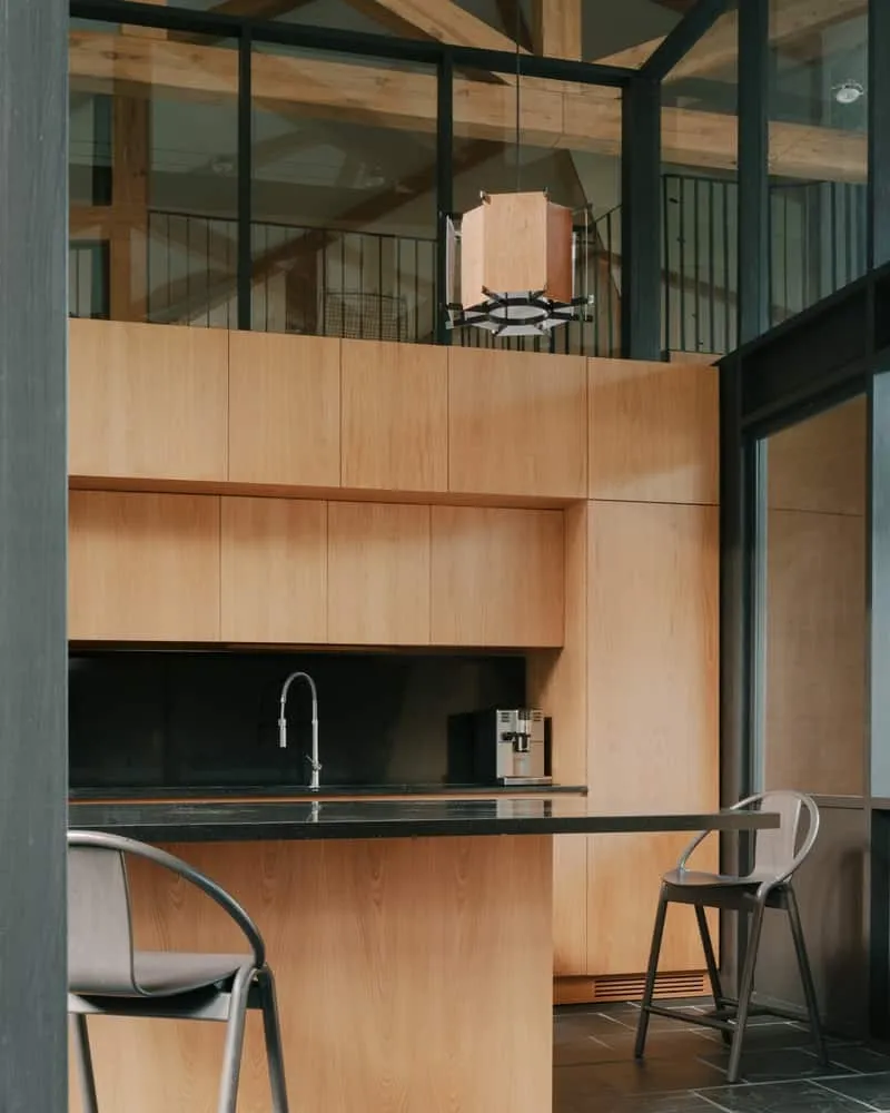 Entrance courtyard with stone tiles and wooden awning forming an inviting protected threshold.
