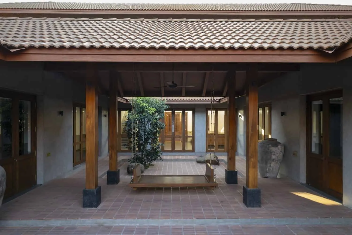 Wide view of house low on fields with two courtyards organizing the plan.