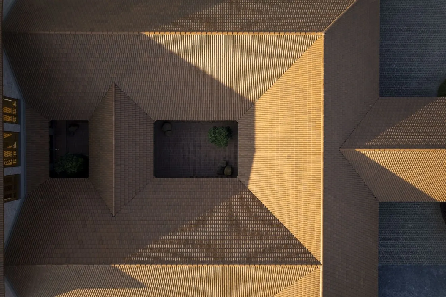 Wooden ceiling elements rhythmically extending over the shaded veranda.