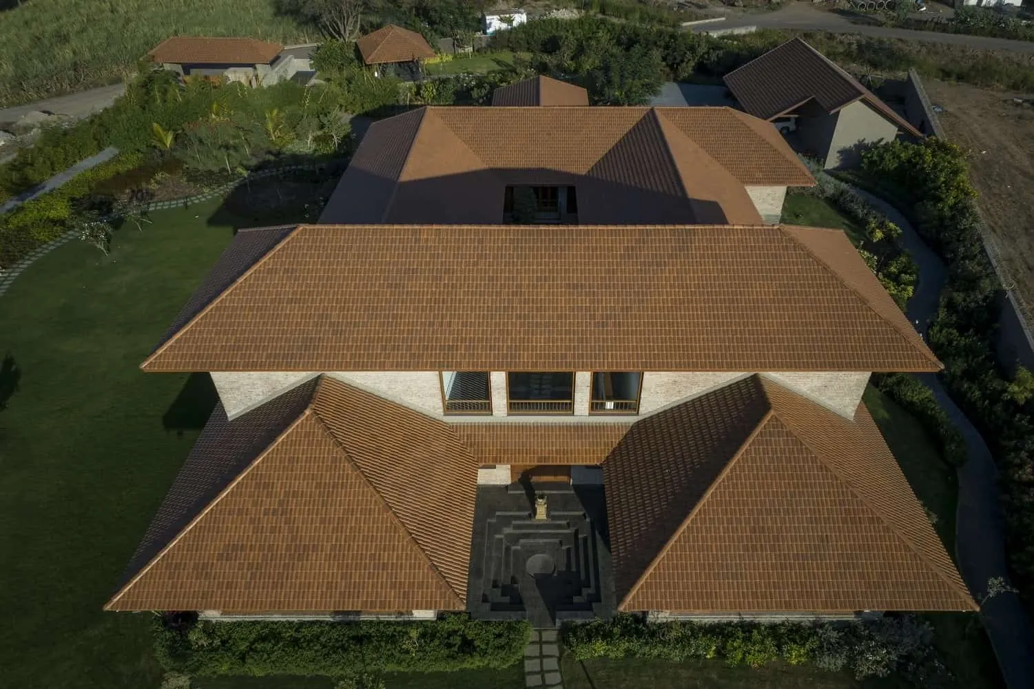 Detail of exposed joints and handcrafted brick textures reflecting angled light.