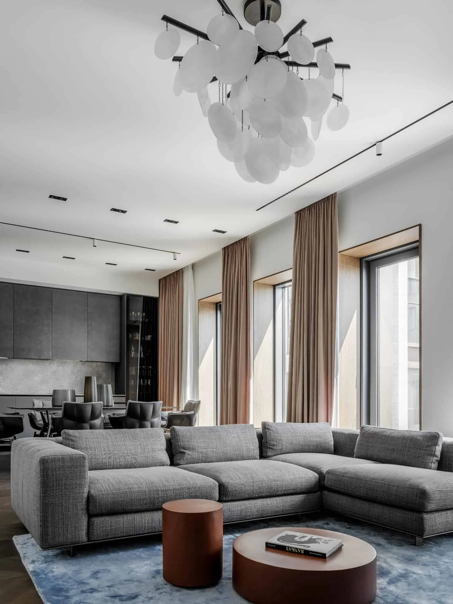 Spacious living room with modern chandelier.