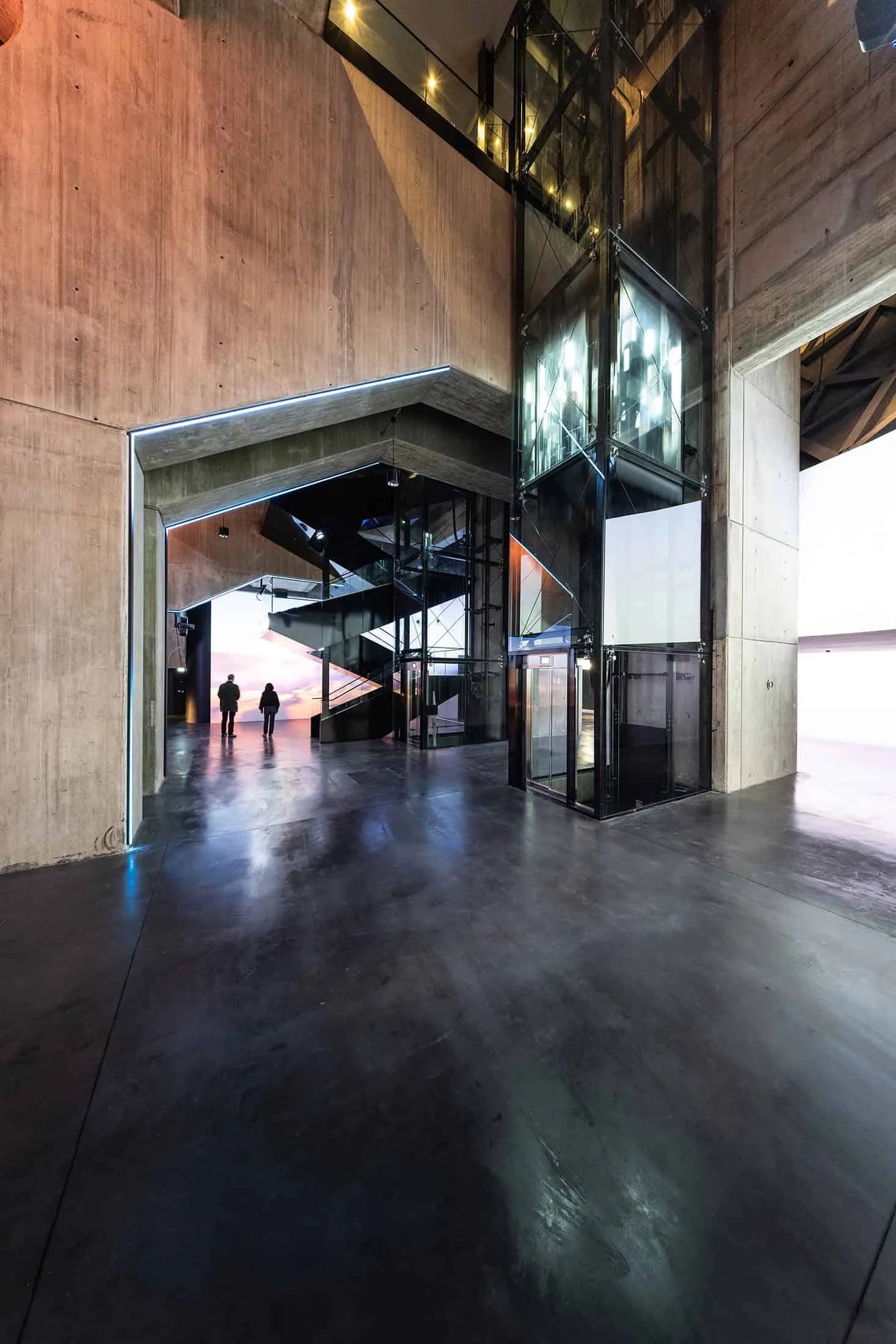 Structural details of La Géode with raw concrete and glass elevator.