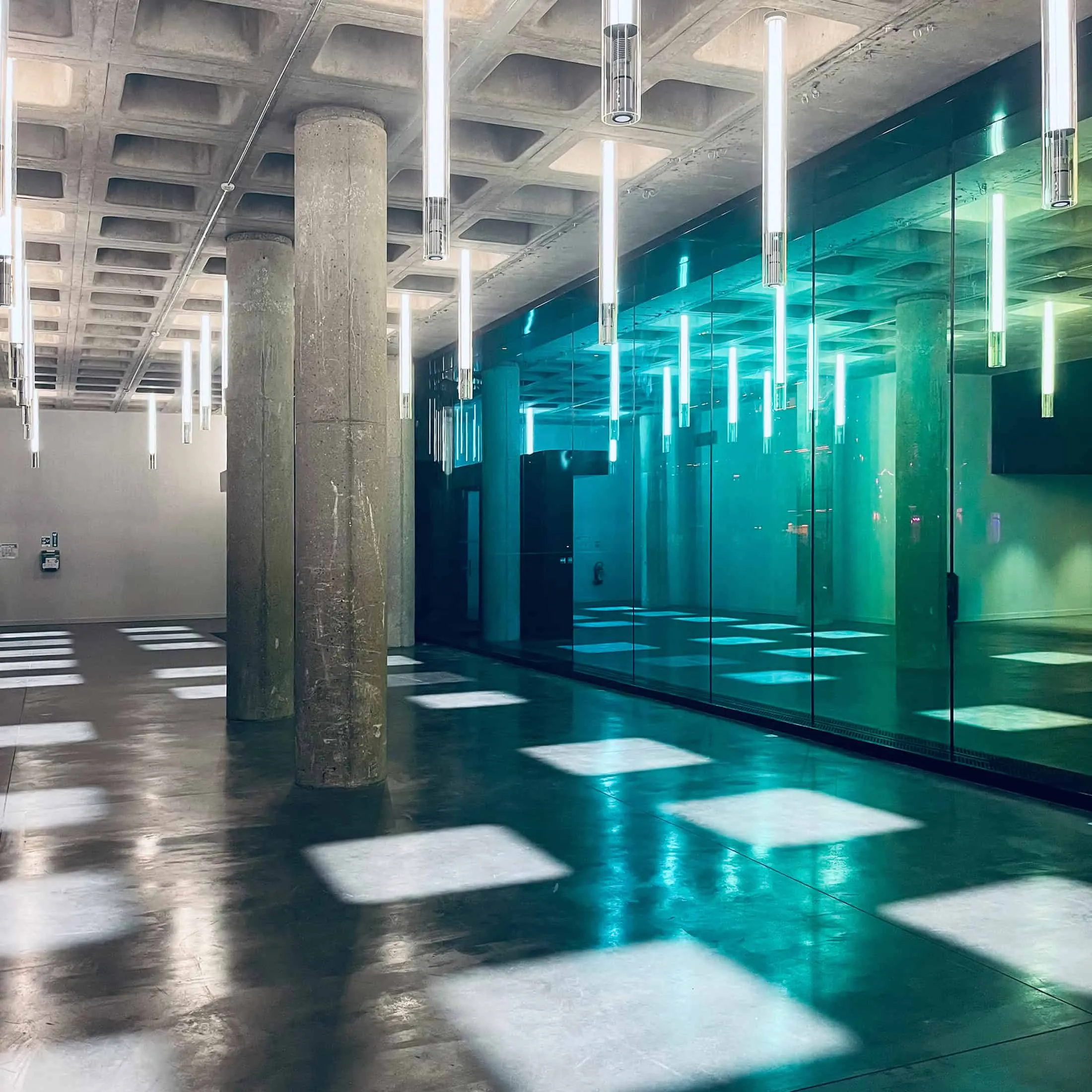 Minimalist glass space in the lobby with geometric lighting inside La Géode.