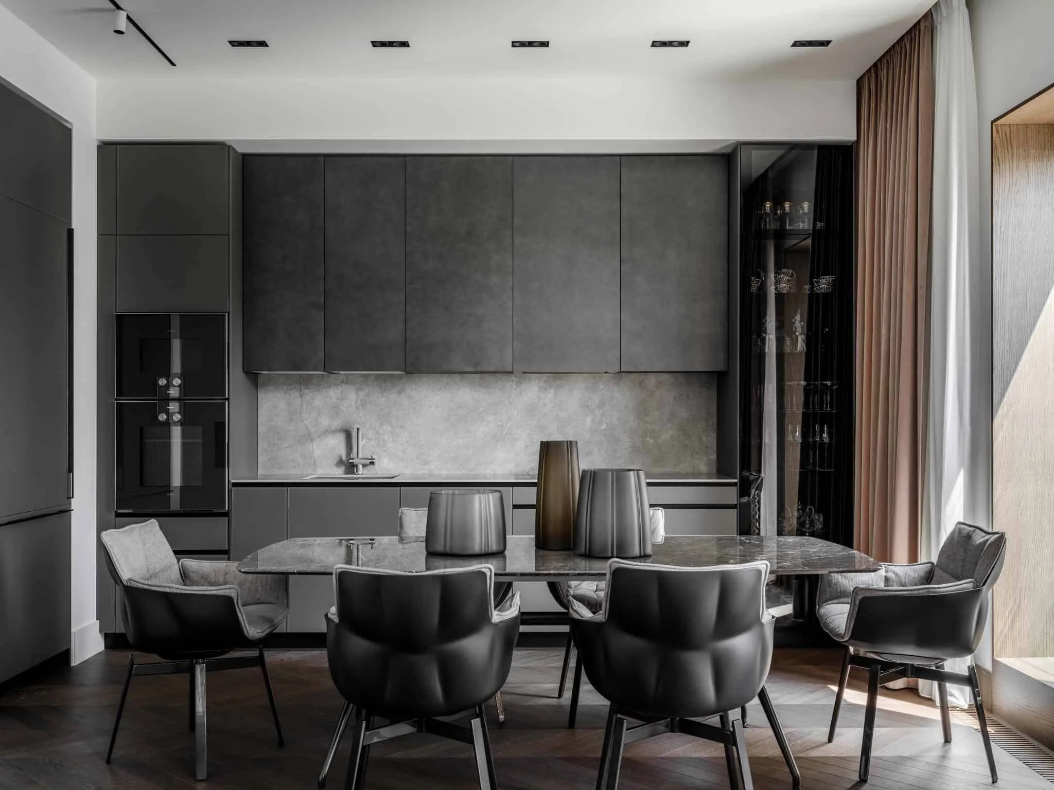Elegant black chairs and gray kitchen.