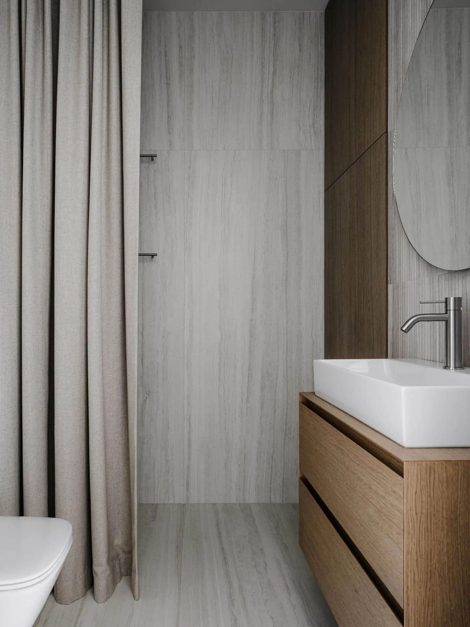 Textured bathroom wall with wall-mounted sink.