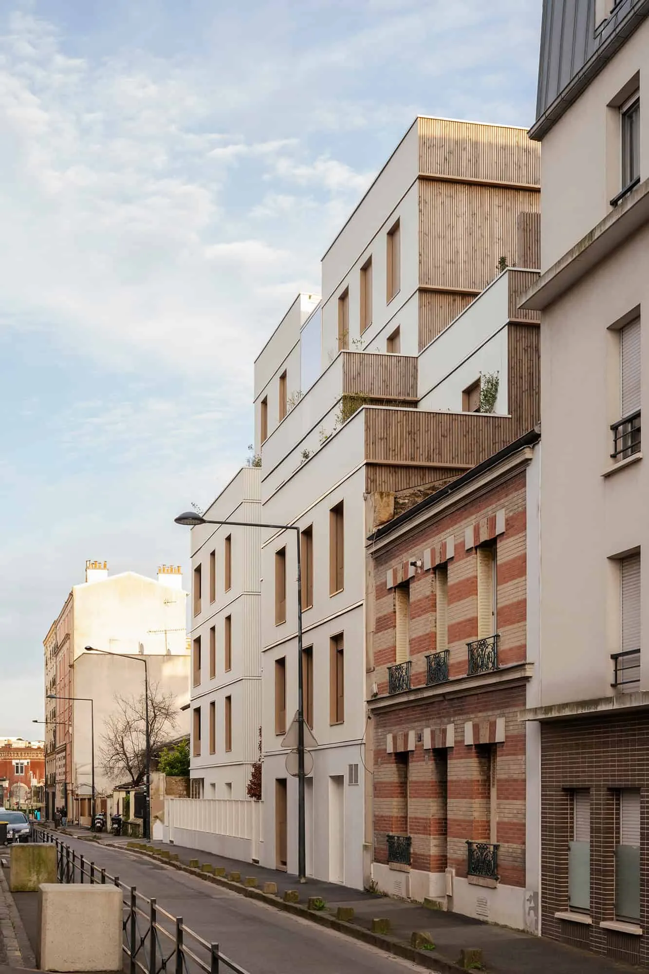 Street view showing modern volumes in quiet Parisian suburb