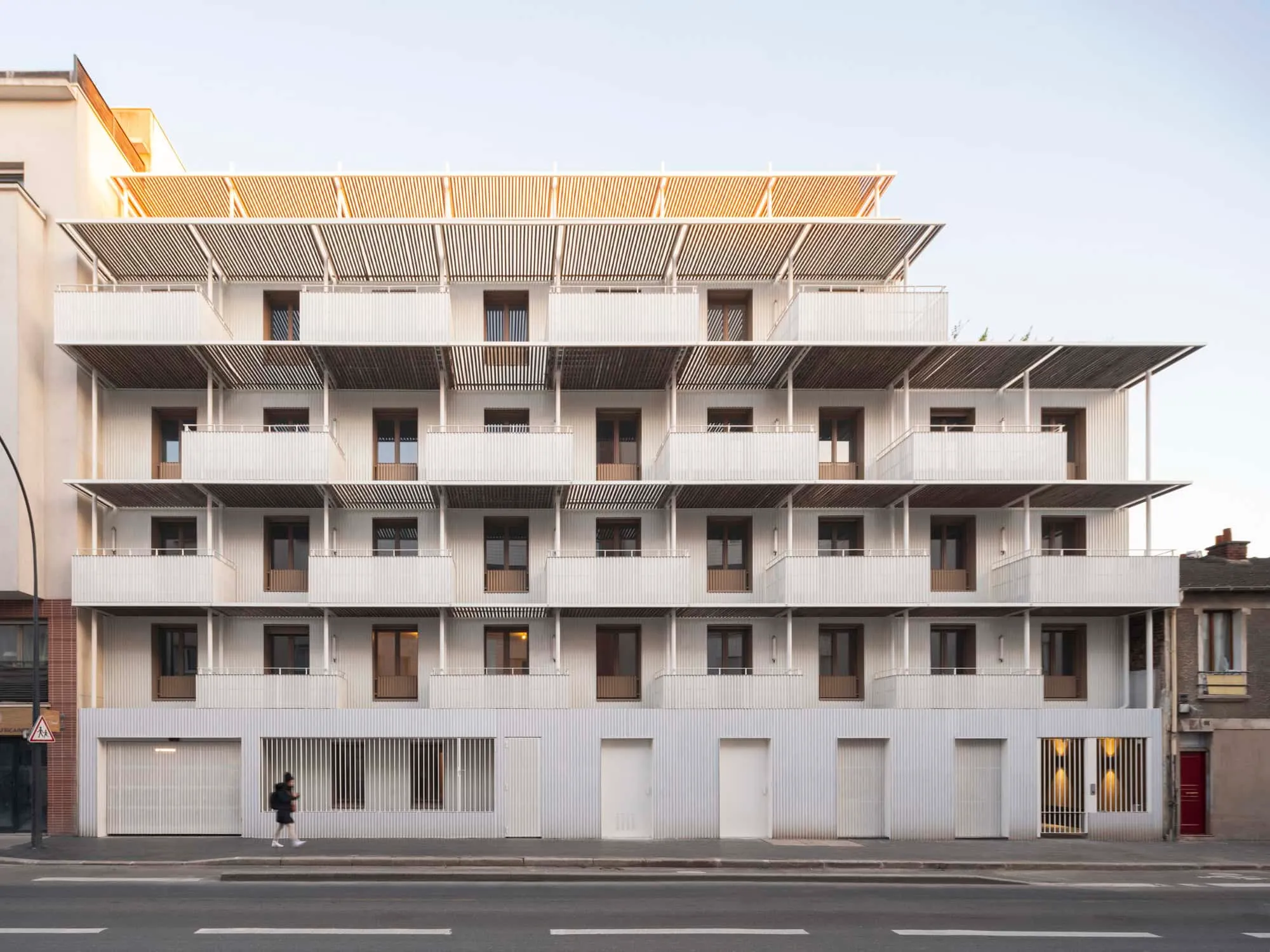 Full façade view of the Saint-Denis residential complex with balconies and vertical rhythm