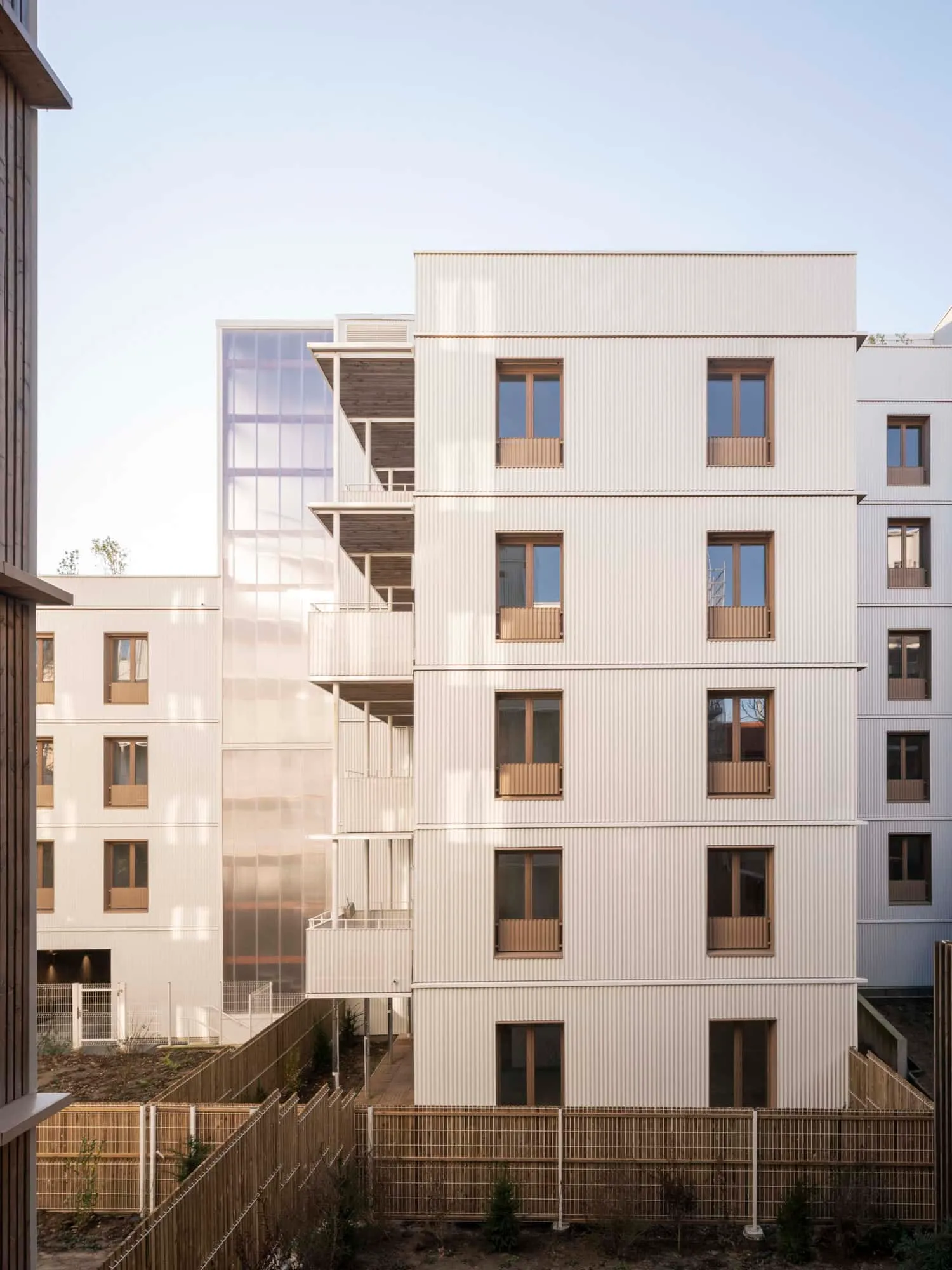 Interior courtyard of the Saint-Denis residential complex with green vegetation fence