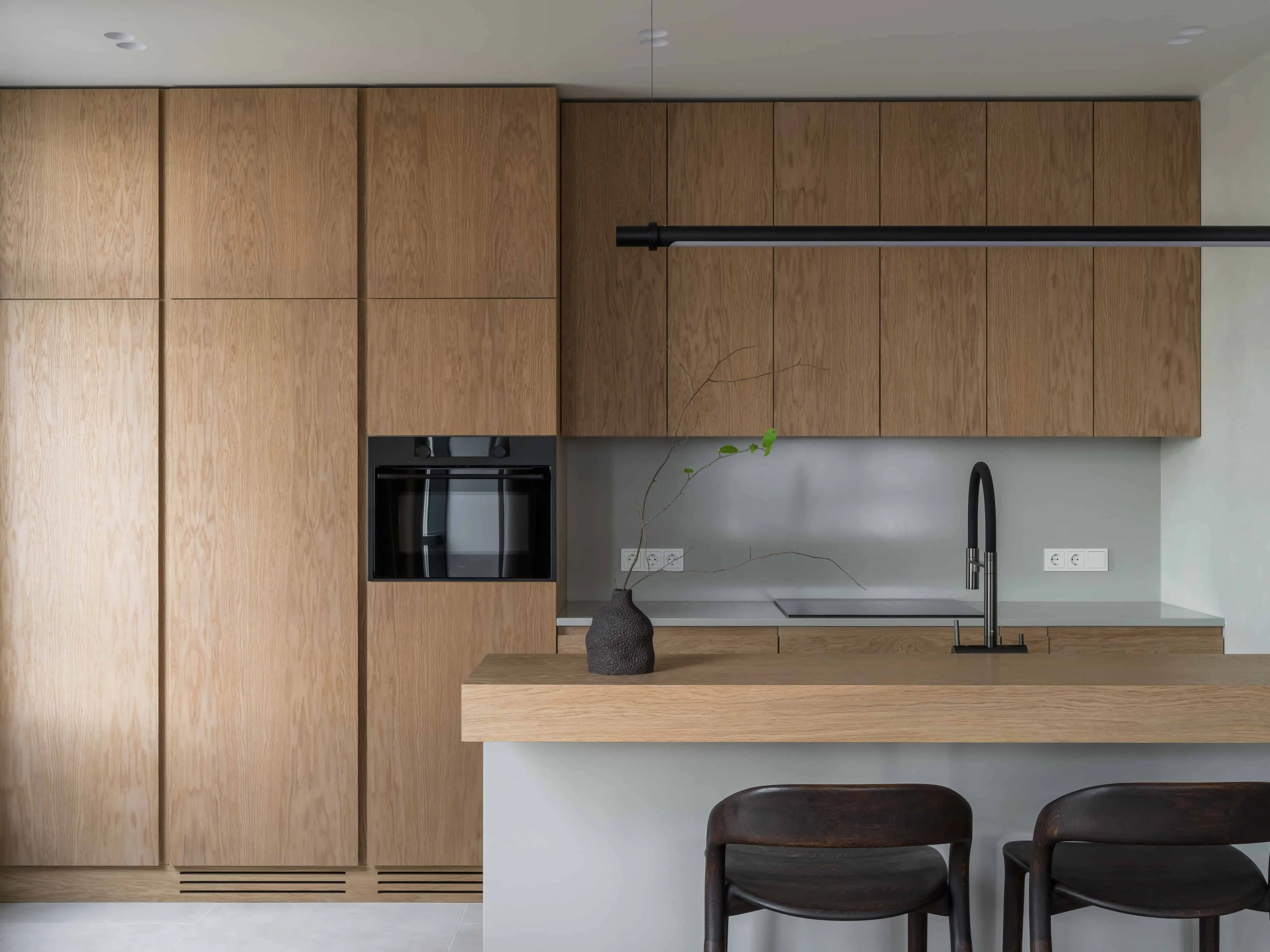 带内置电器的厨房柜子，配简洁线条照明。