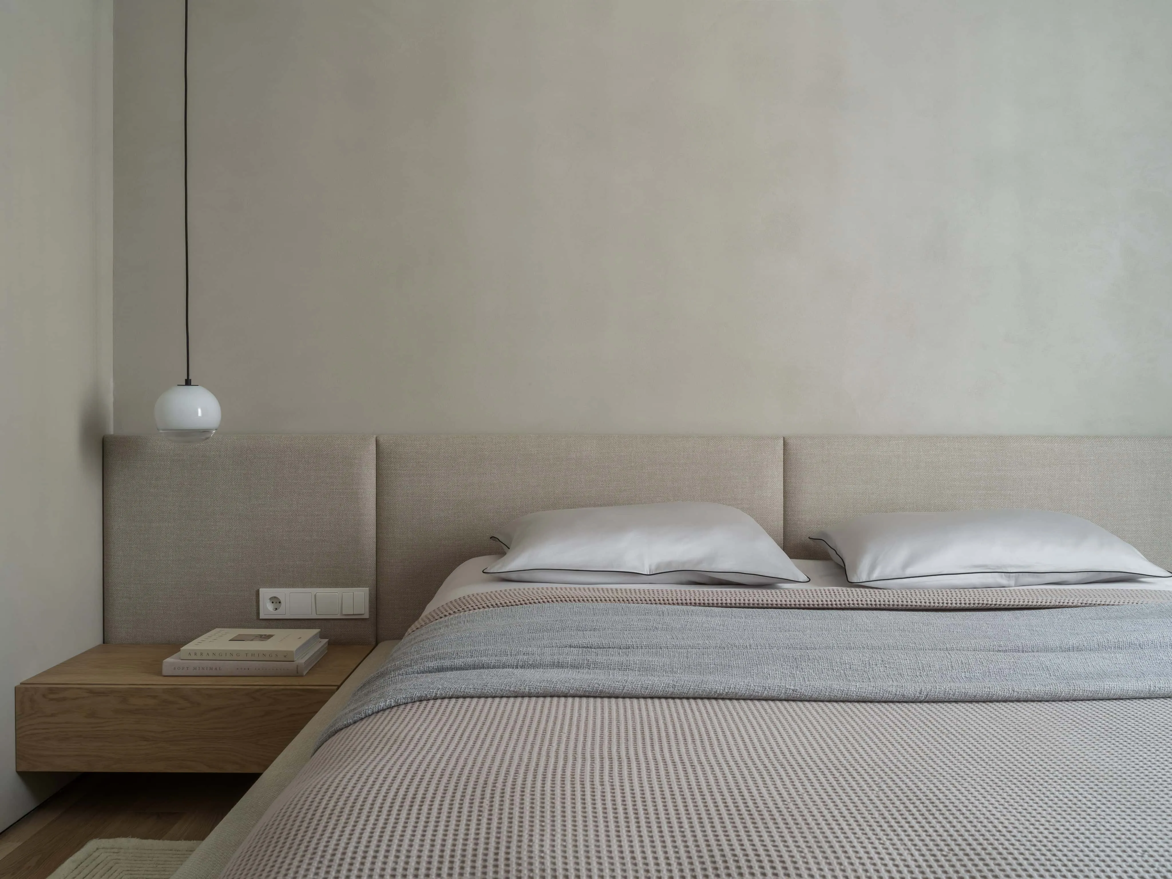 对称现代床，配漂浮床头柜和吊灯。