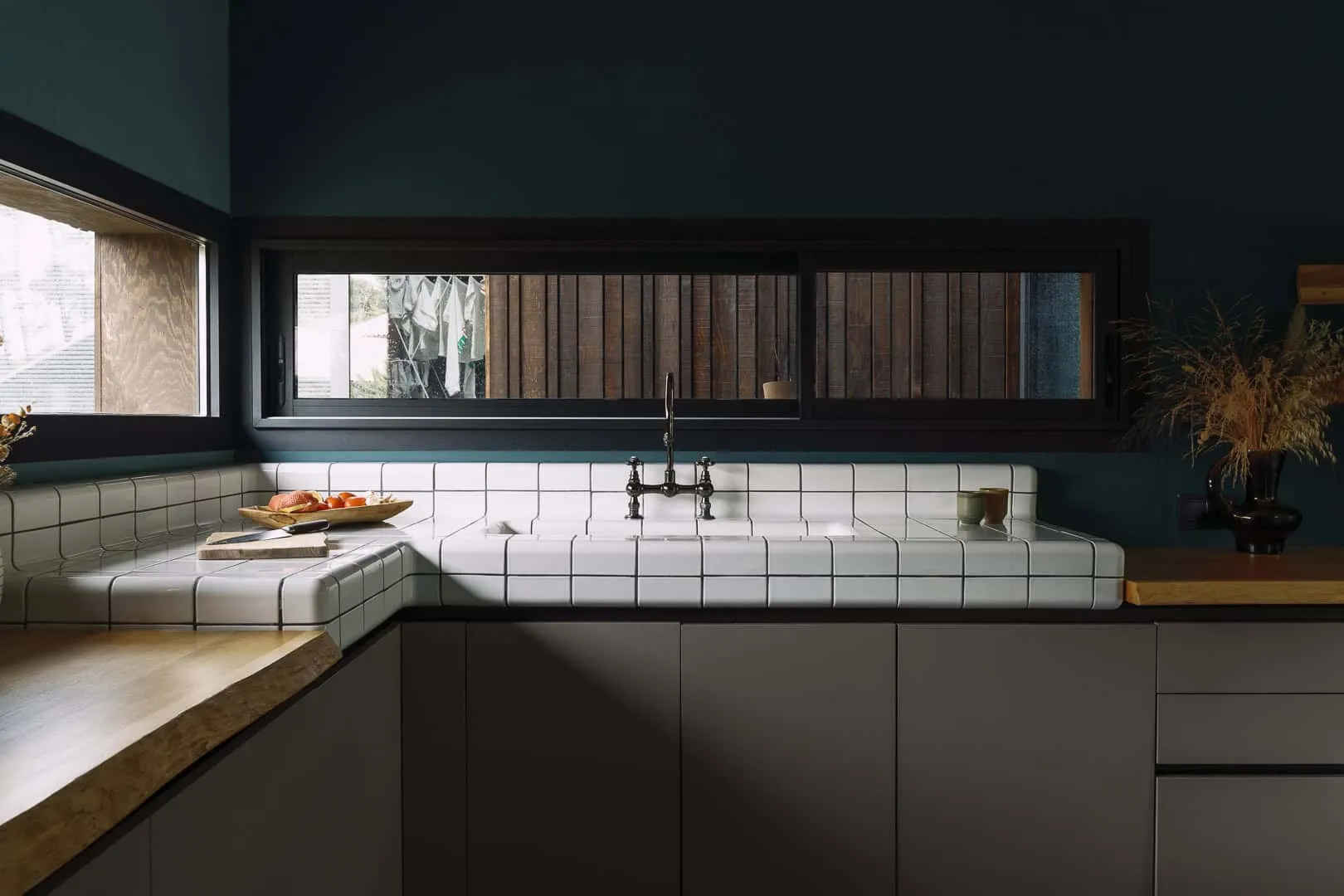 厨房角落带有计数器瓷砖 厨房角落配有白色瓷砖和活体木饰面。