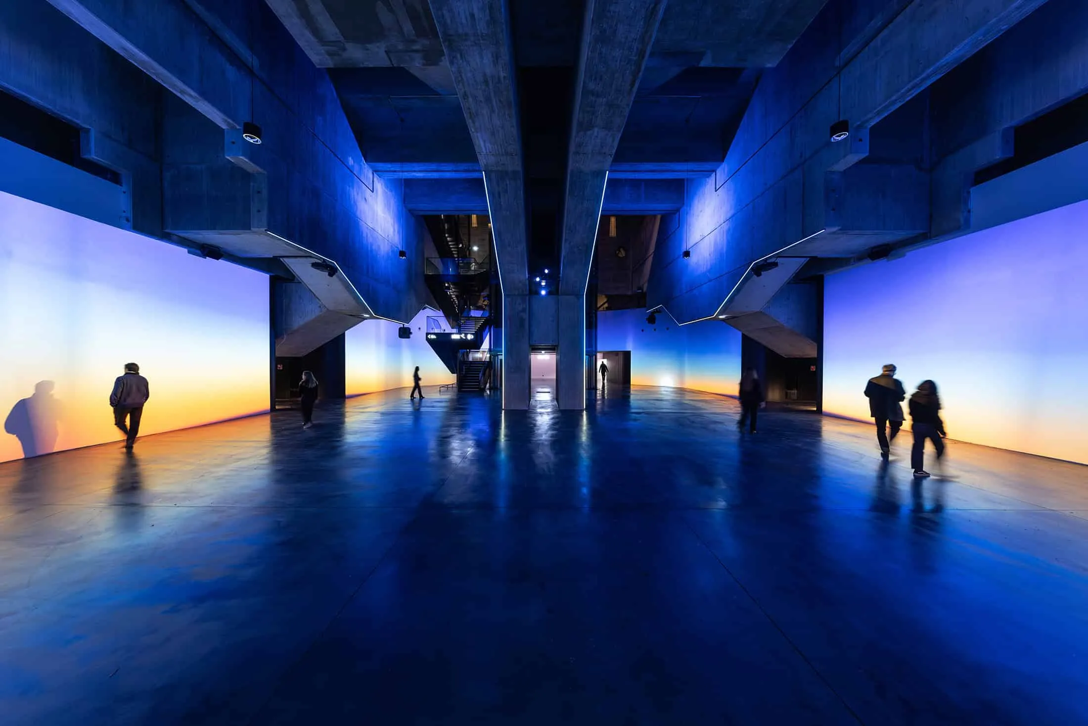 Color interior installation with concrete beams and gradient walls in La Géode.
