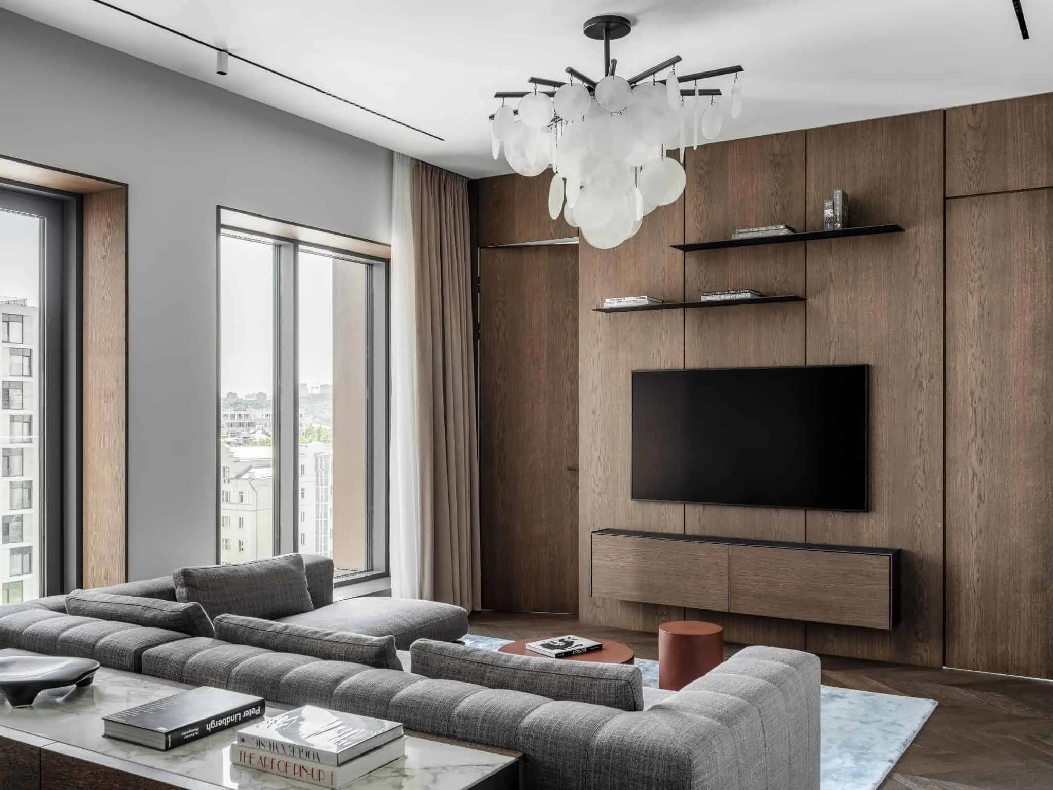 Modern living room with TV and wooden wall.