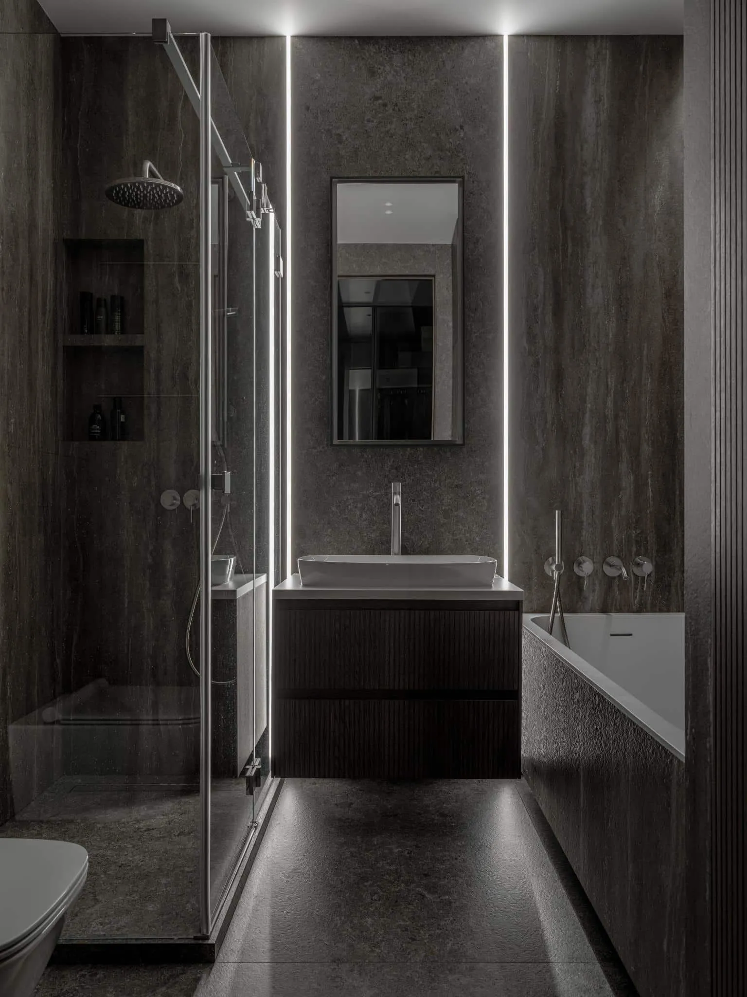 Dark bathroom with vertical lighting.