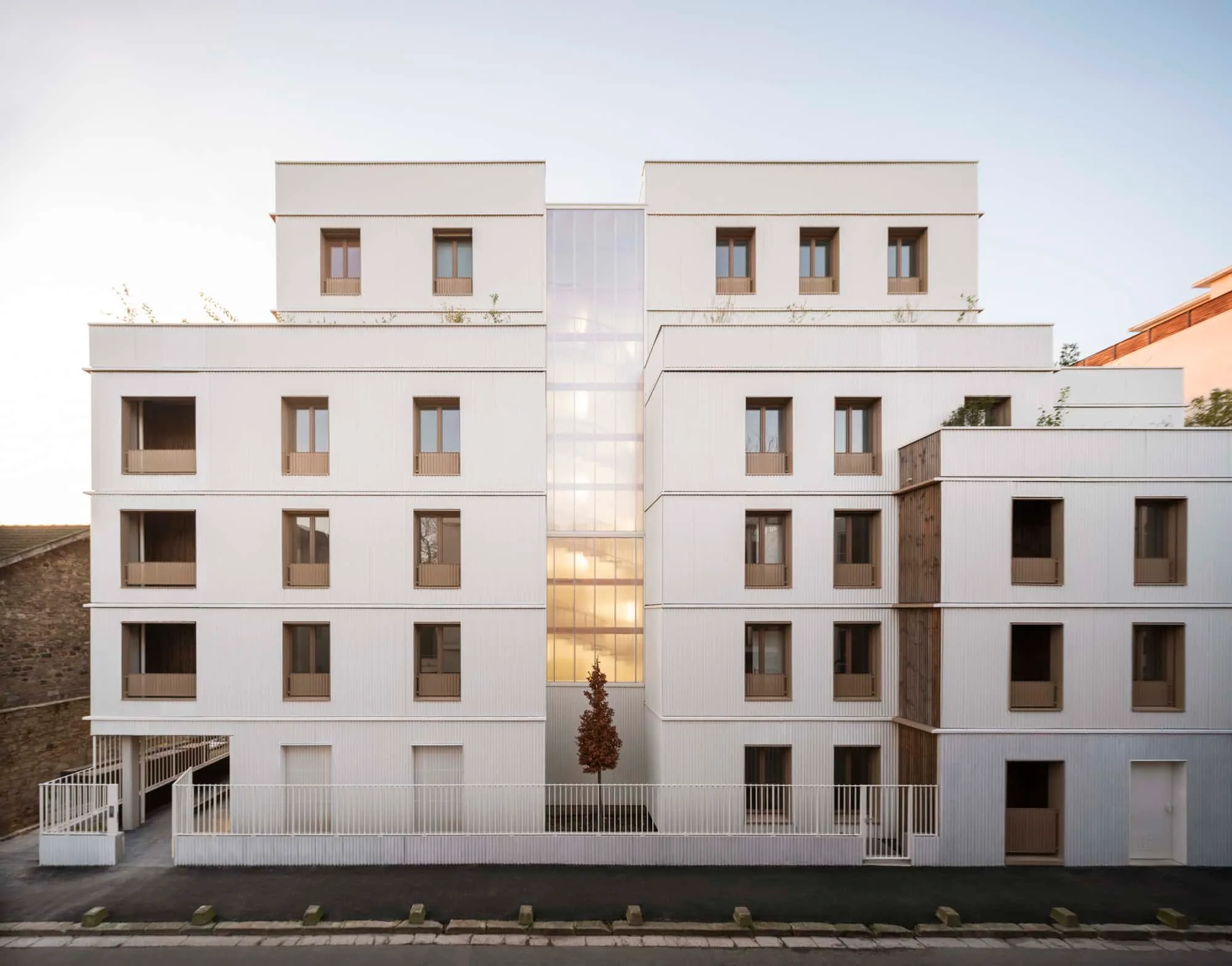 Front view of the Saint-Denis residential complex with minimalist white façade and lattice window pattern