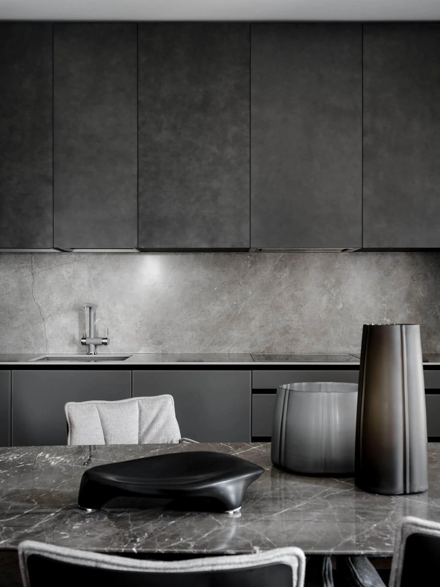 Minimalist kitchen facades and marble table.