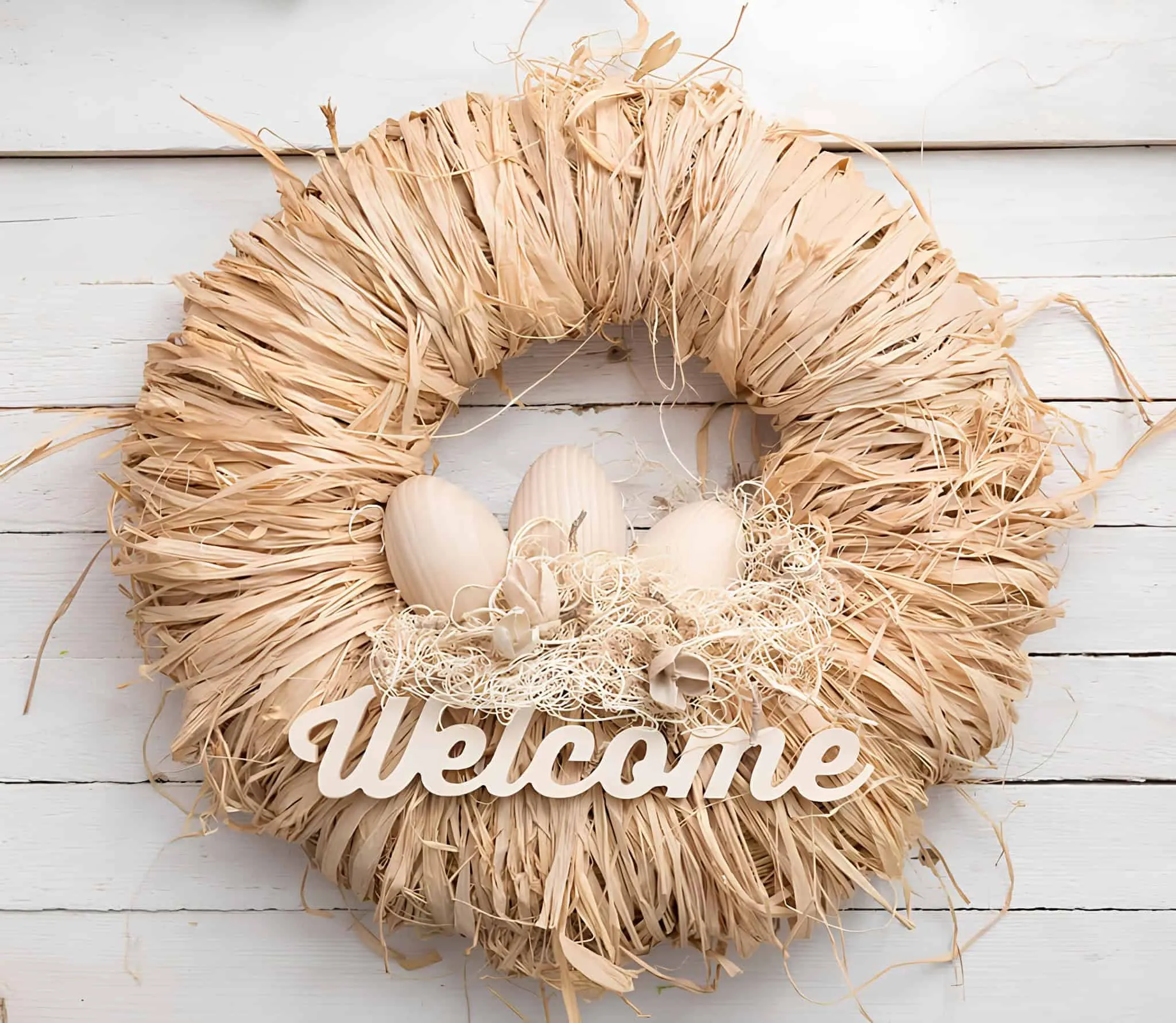 乡村复活节门饰，配有稻草、木鸡蛋和欢迎标志