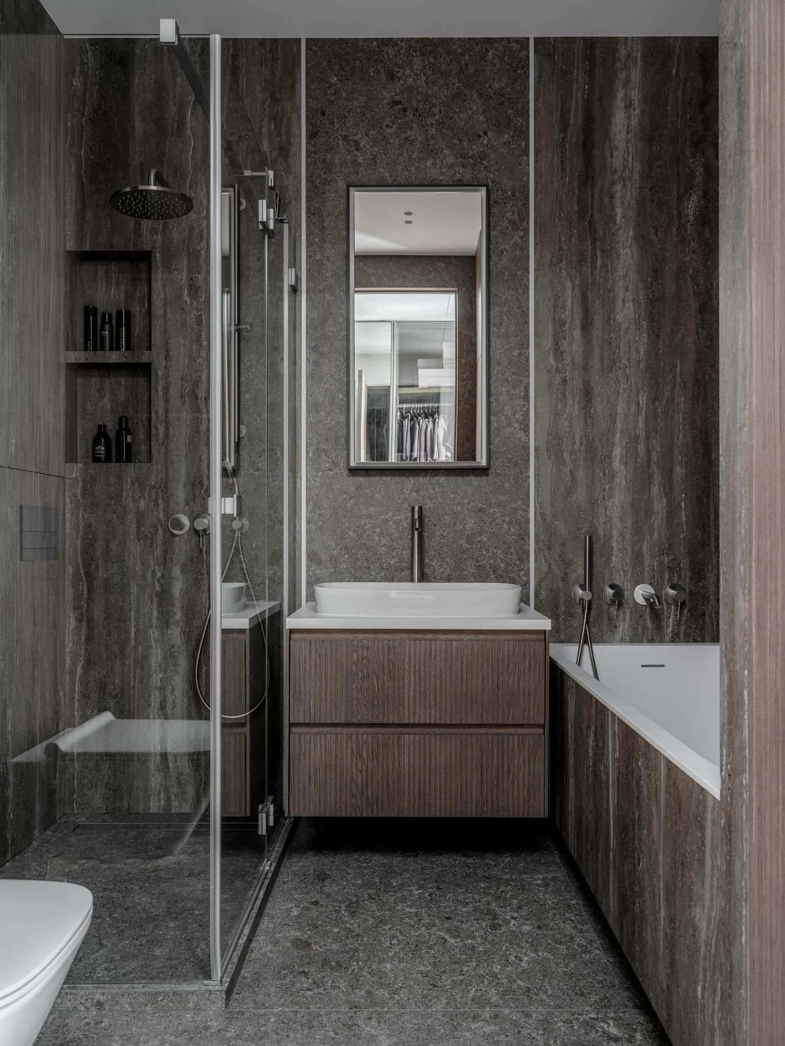 Compact bathroom with shower and bathtub.