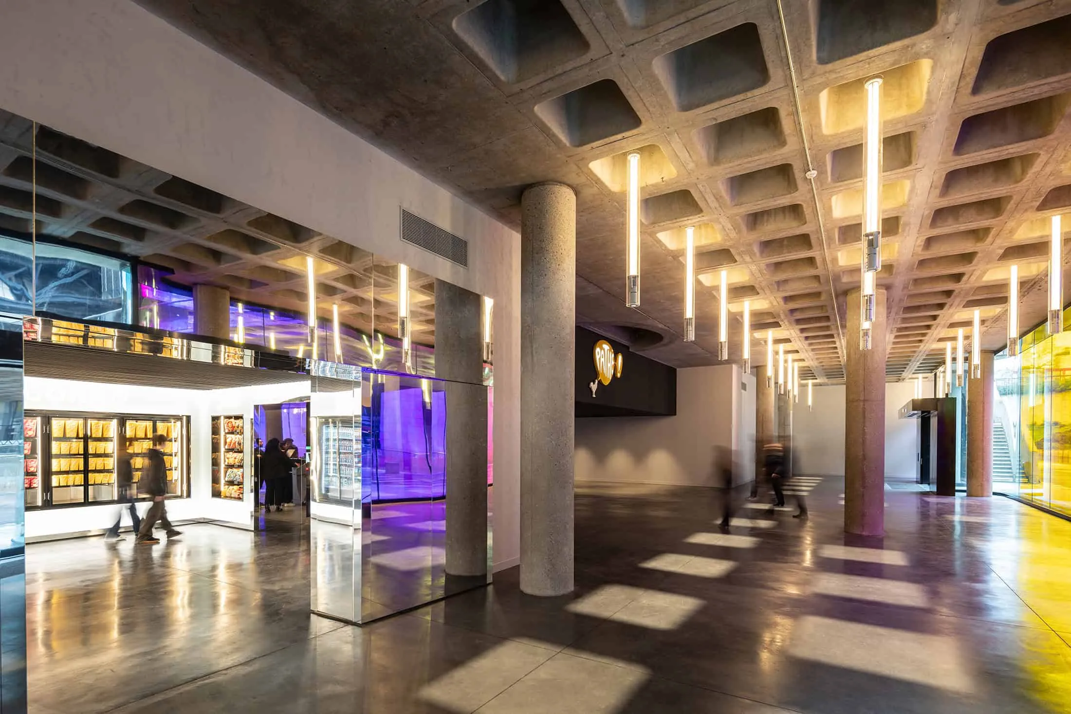 Interior view of the La Géode lobby with a popcorn machine and modern lighting.