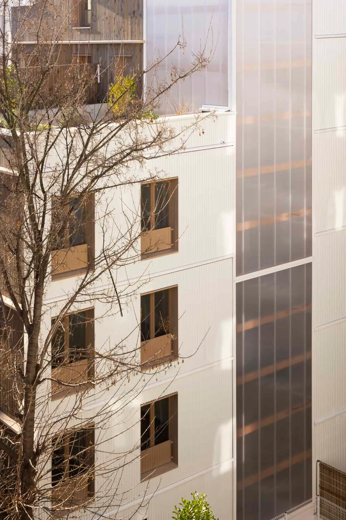 Semi-transparent polycarbonate walkway connecting apartments of the Saint-Denis residential complex