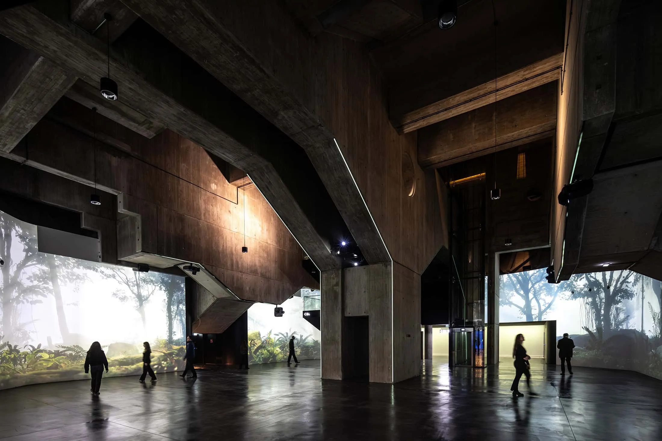 Industrial interior of La Géode with exposed concrete and interactive projections.