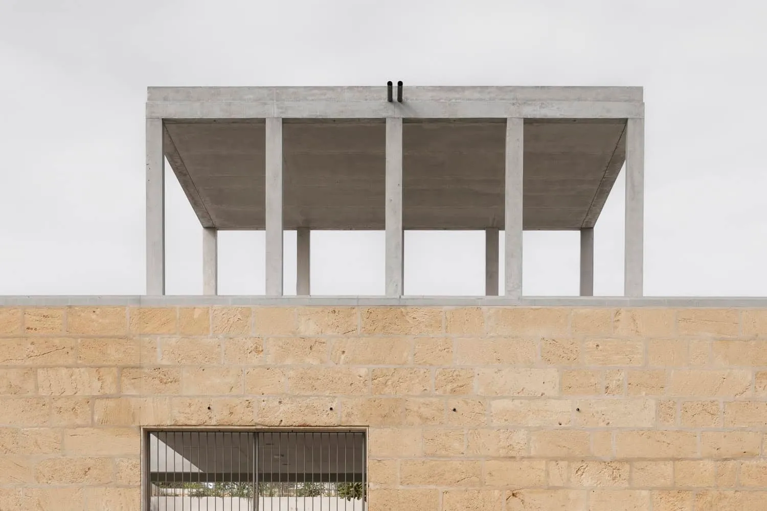 Contrasting stone and concrete in upper facade volume of Newcastle