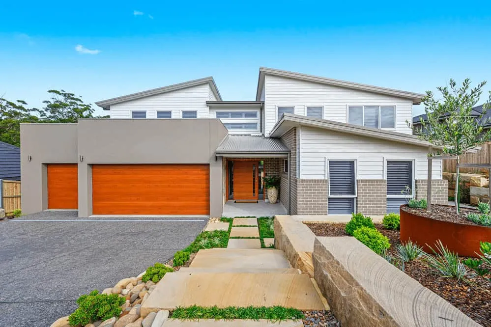 Modern house with a skillion roof, wooden gates and minimalist landscape