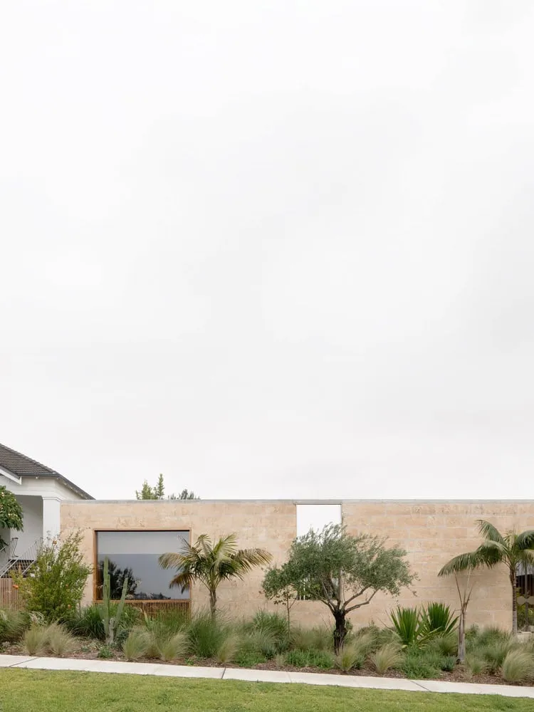 Low limestone wall and lush landscape facing the street in Newcastle