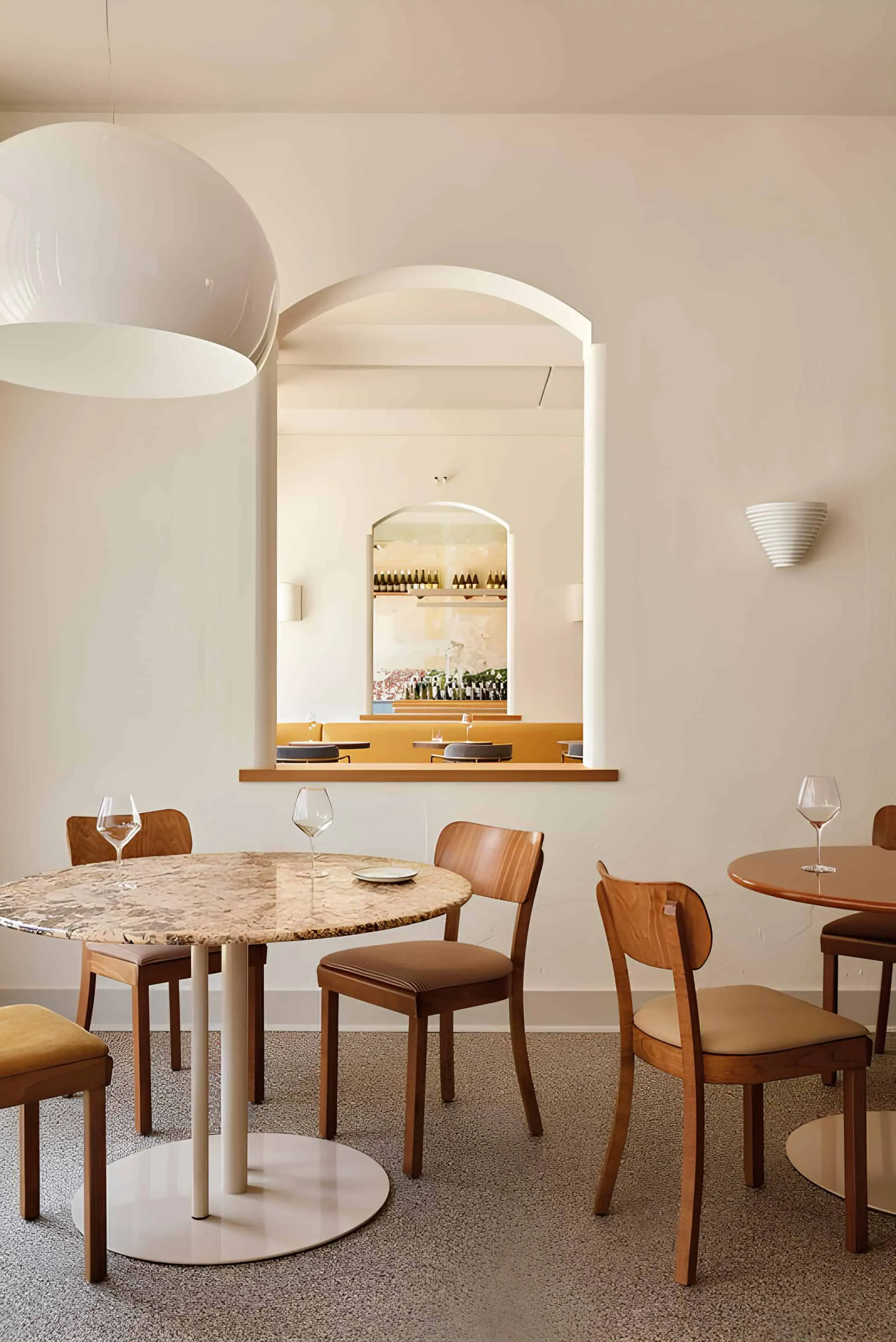Dining area at Vin Populi with marble table and warm lighting