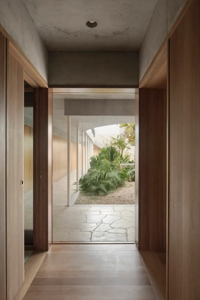 Interior view of hall leading to lush garden courtyard in Newcastle