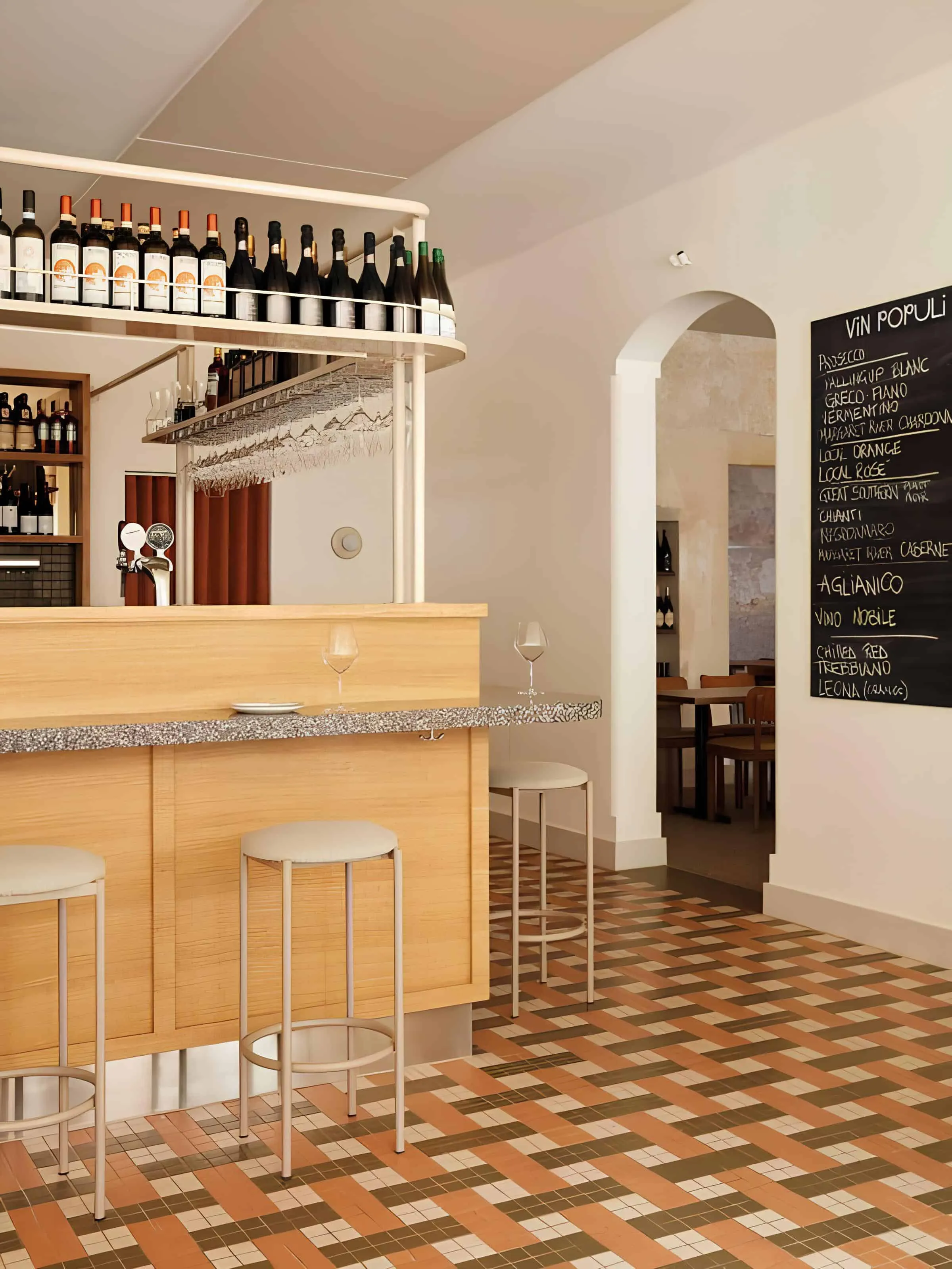 Vin Populi wine bar with terrazzo counter and bottle display, designed by Rezen Studio