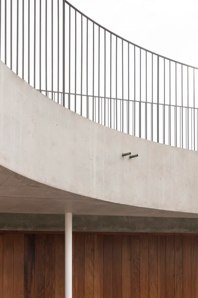 Architectural detail of curved concrete fence with vertical balustrade in Newcastle
