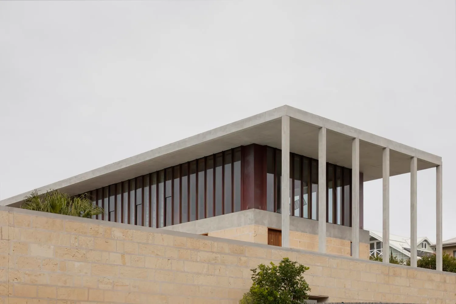 Modern roof supported by columns with full glass walls in Newcastle home