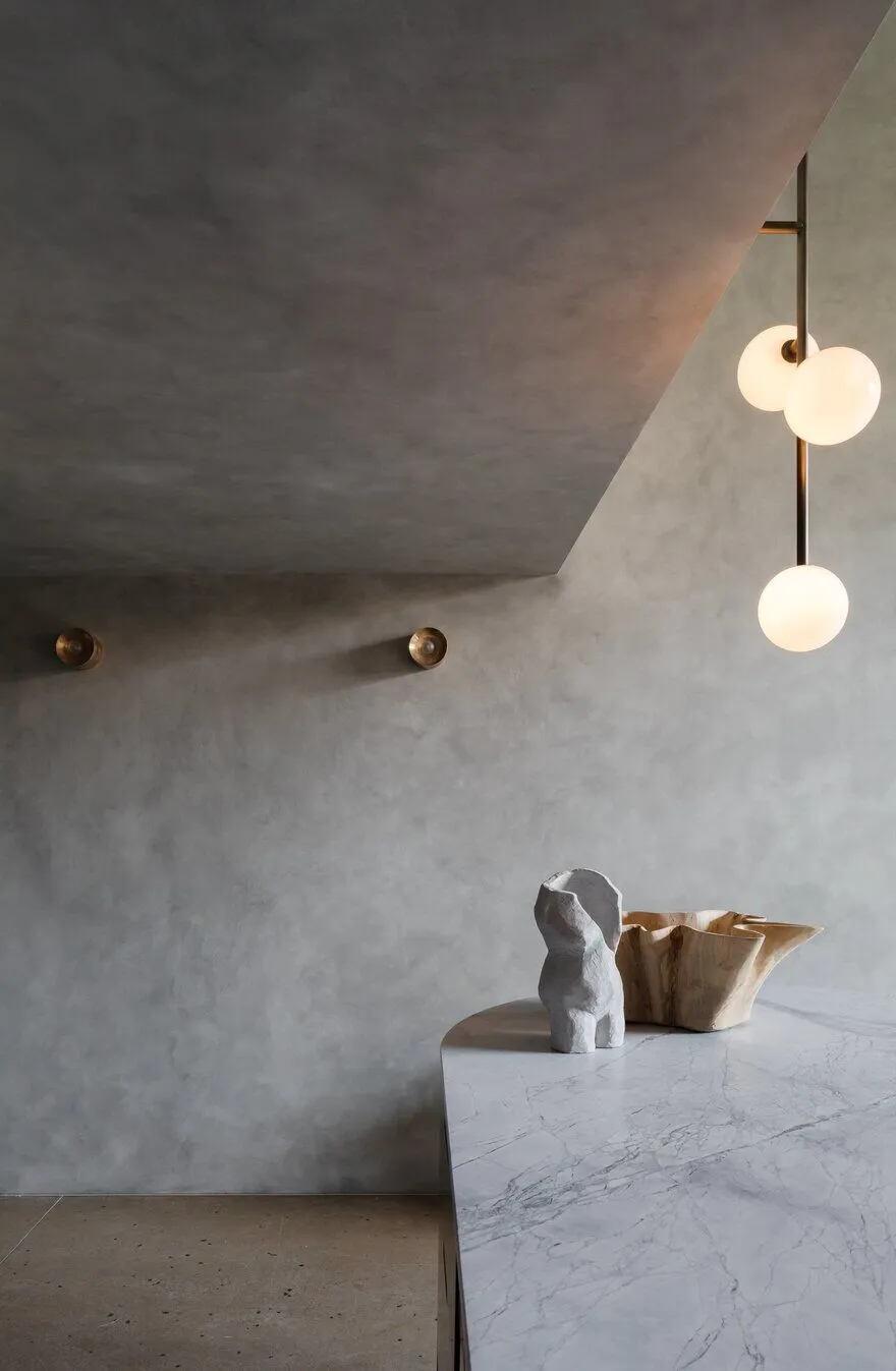 Modern pendant light close to textured brutal ceiling and wall