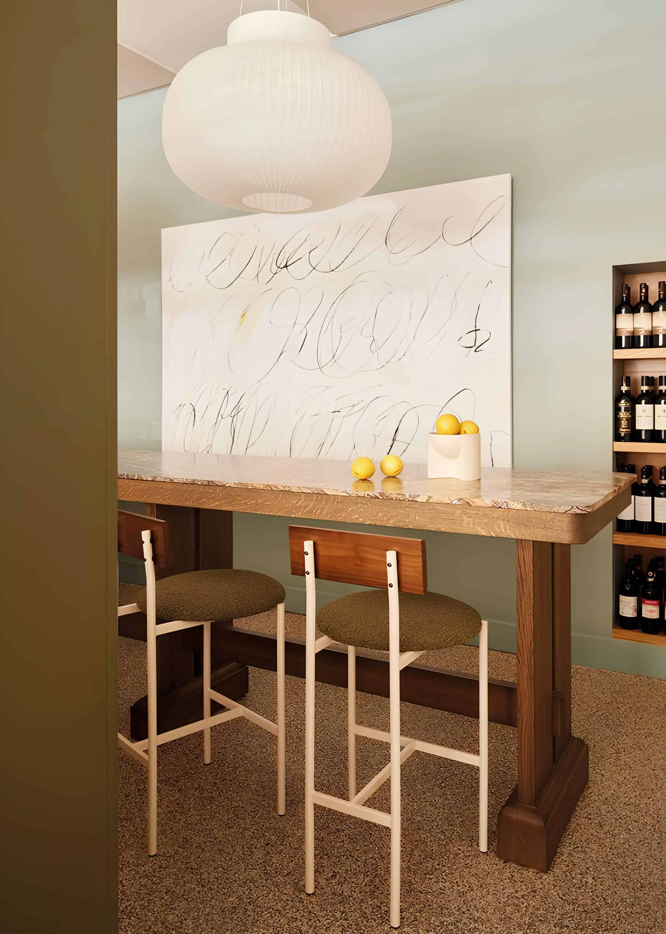 High dining table with pendant lighting and lemon decoration at Vin Populi